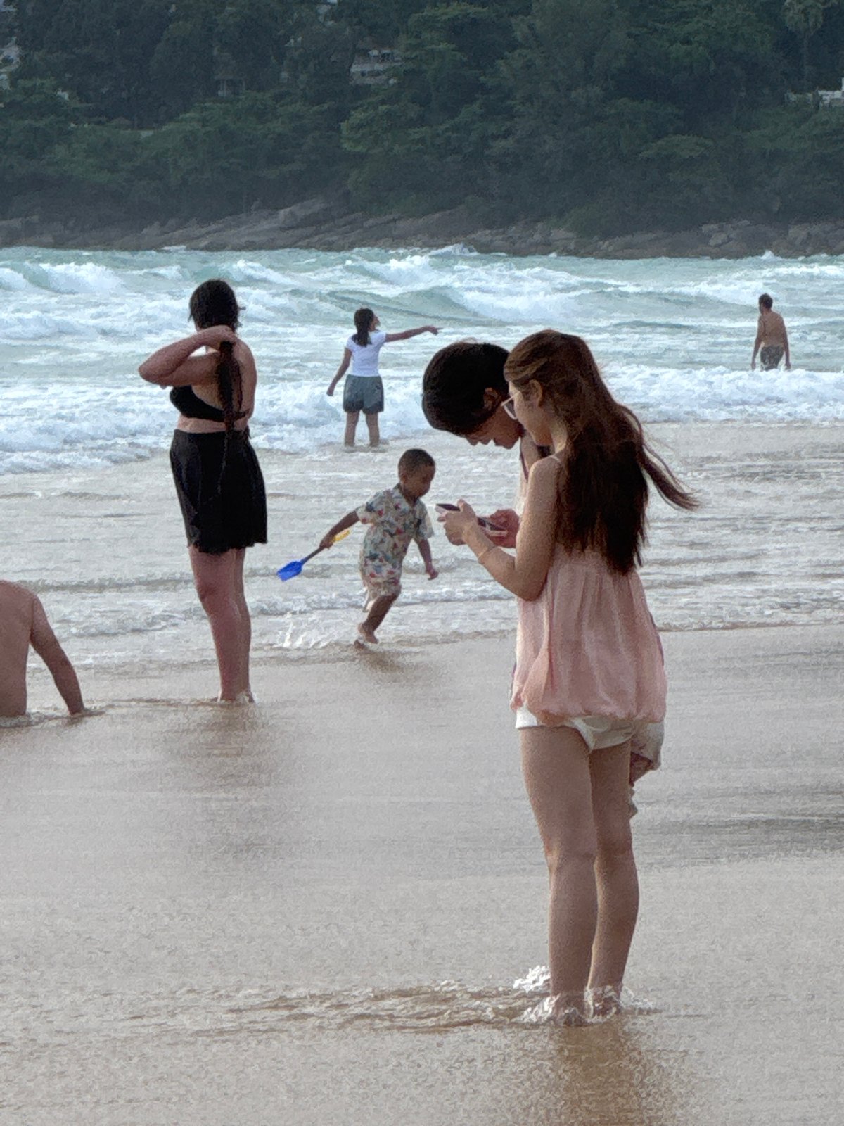 Karon Beach under red flags, surf warnings, and scattered activity