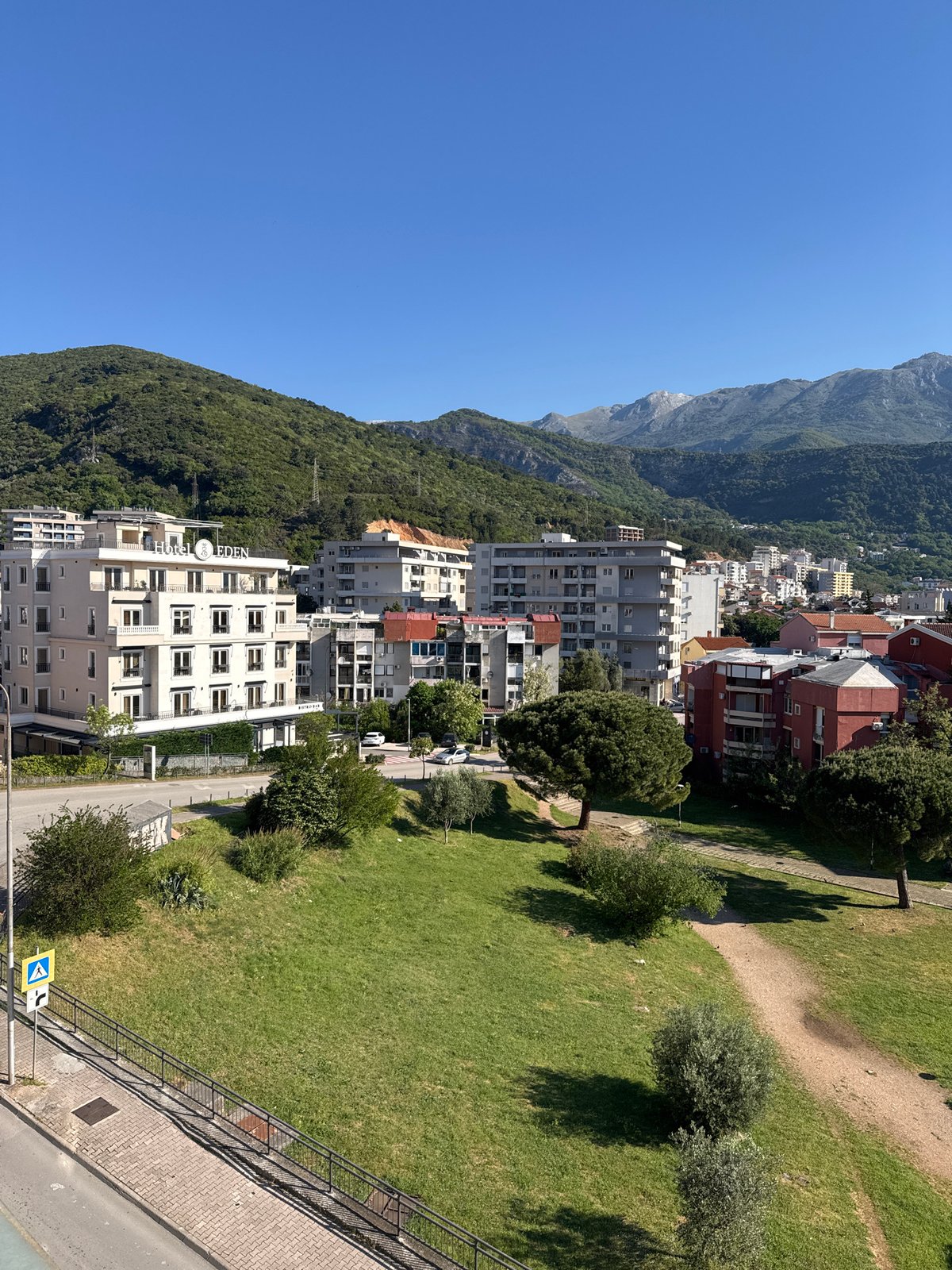 Elevated cityscape view captured showing urban buildings and mountain terrain