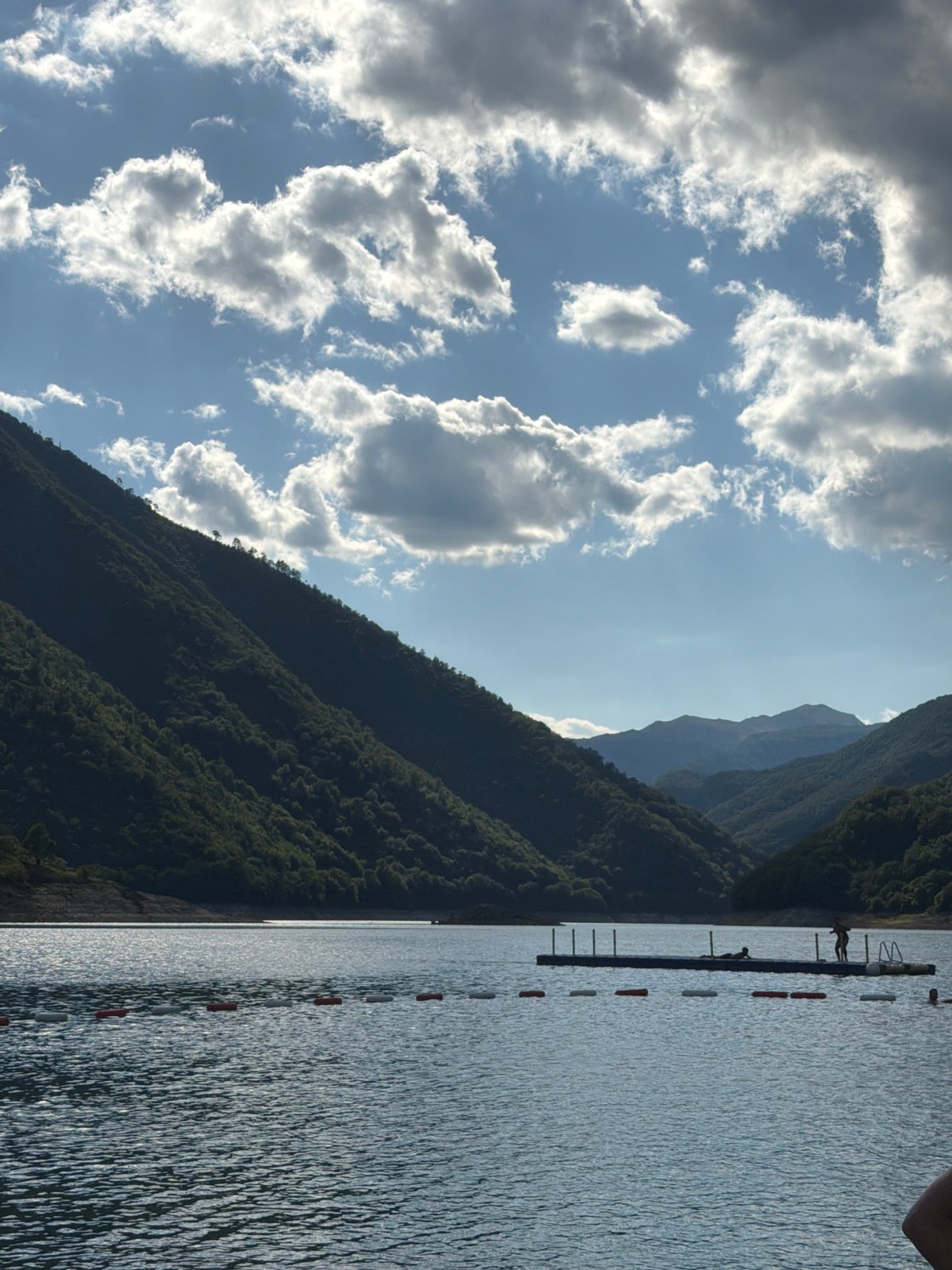 Lazy summer day on Piva Lake's pebble beach