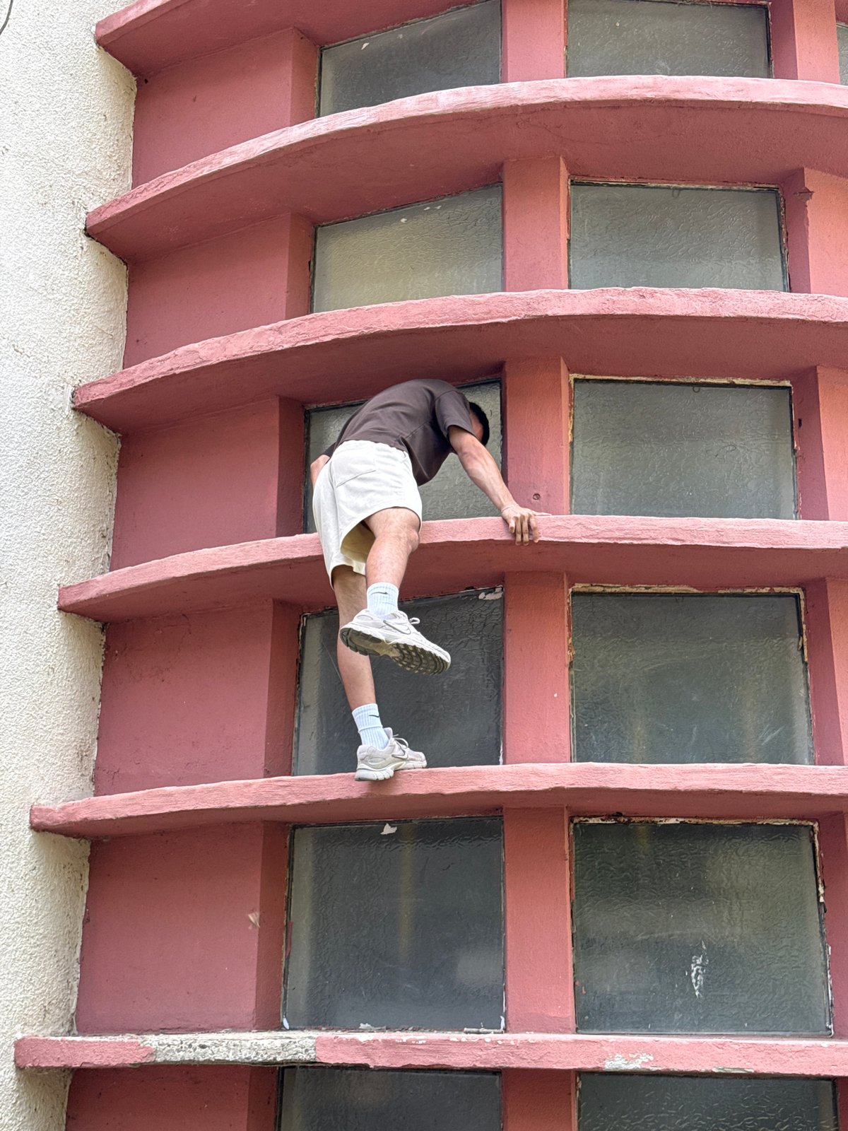 Free-climbing the exterior of a curved building in Shumen