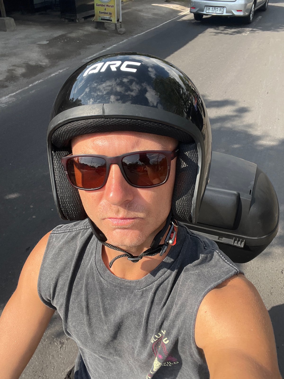 Scooter riding through busy Sukawati streets on a sunny Bali morning