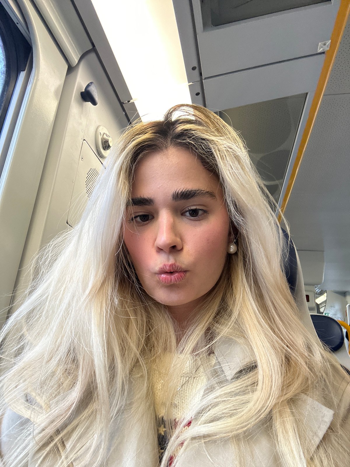 Woman takes selfie while traveling by train in Milan