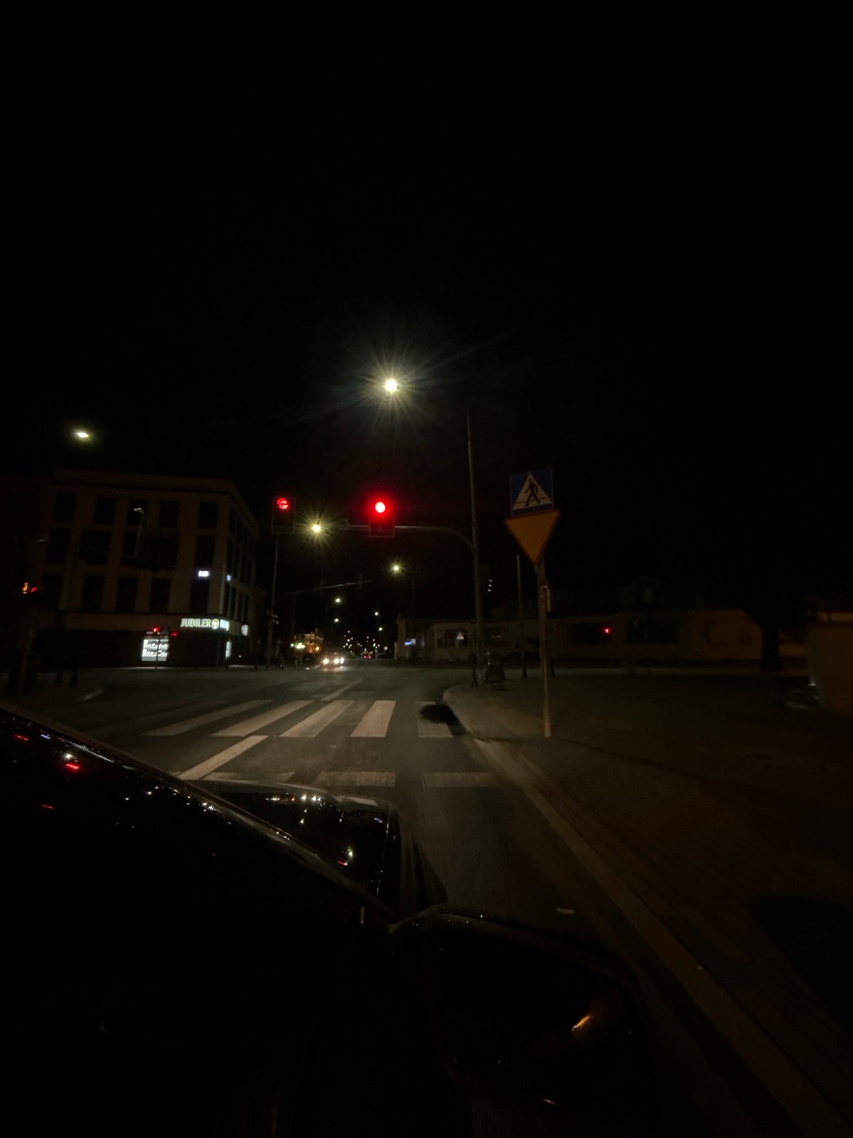 Nighttime drive through Siedlce streets, wet roads and traffic lights
