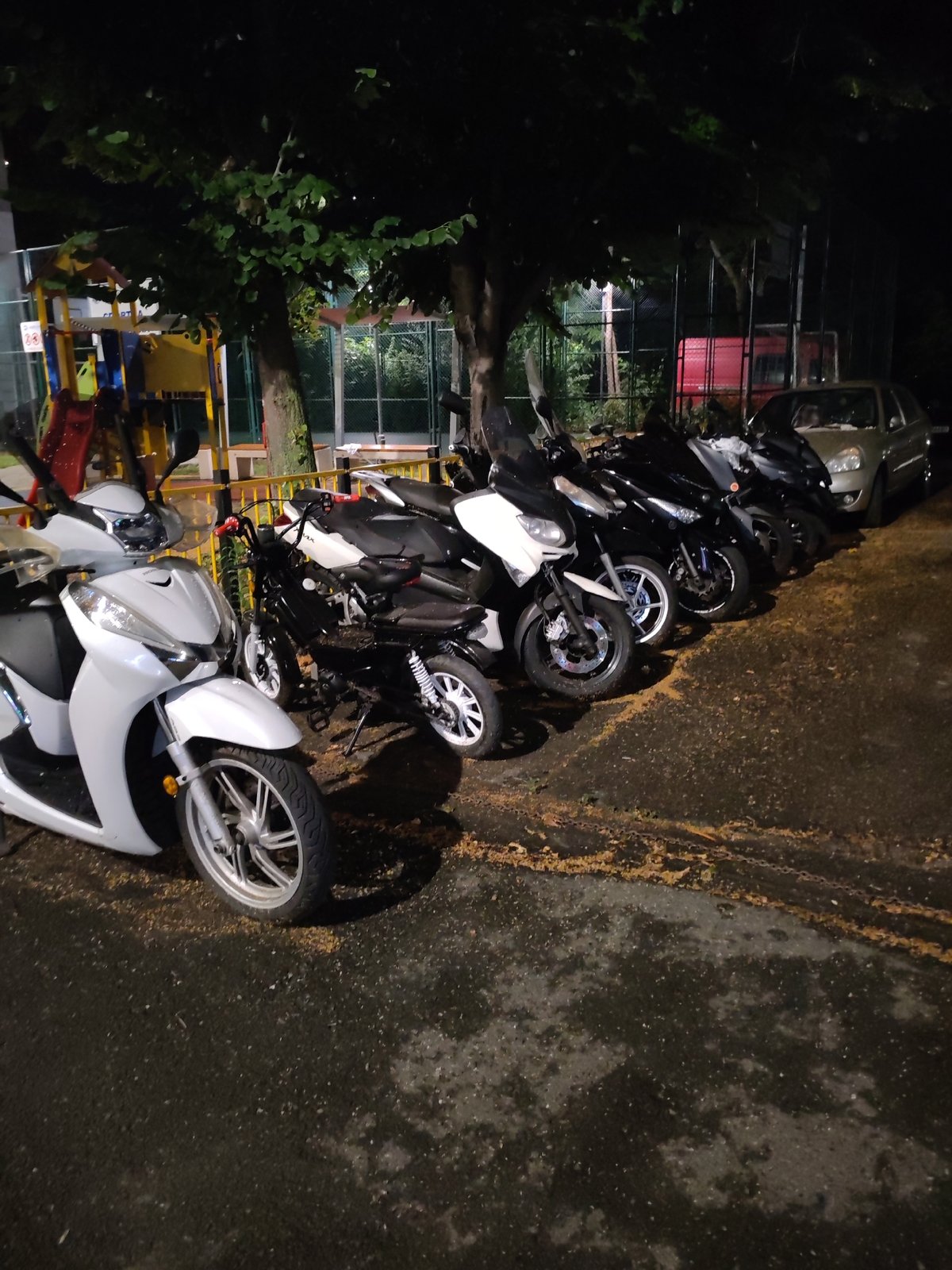 Scooters and motorcycles parked at night in Nesebar