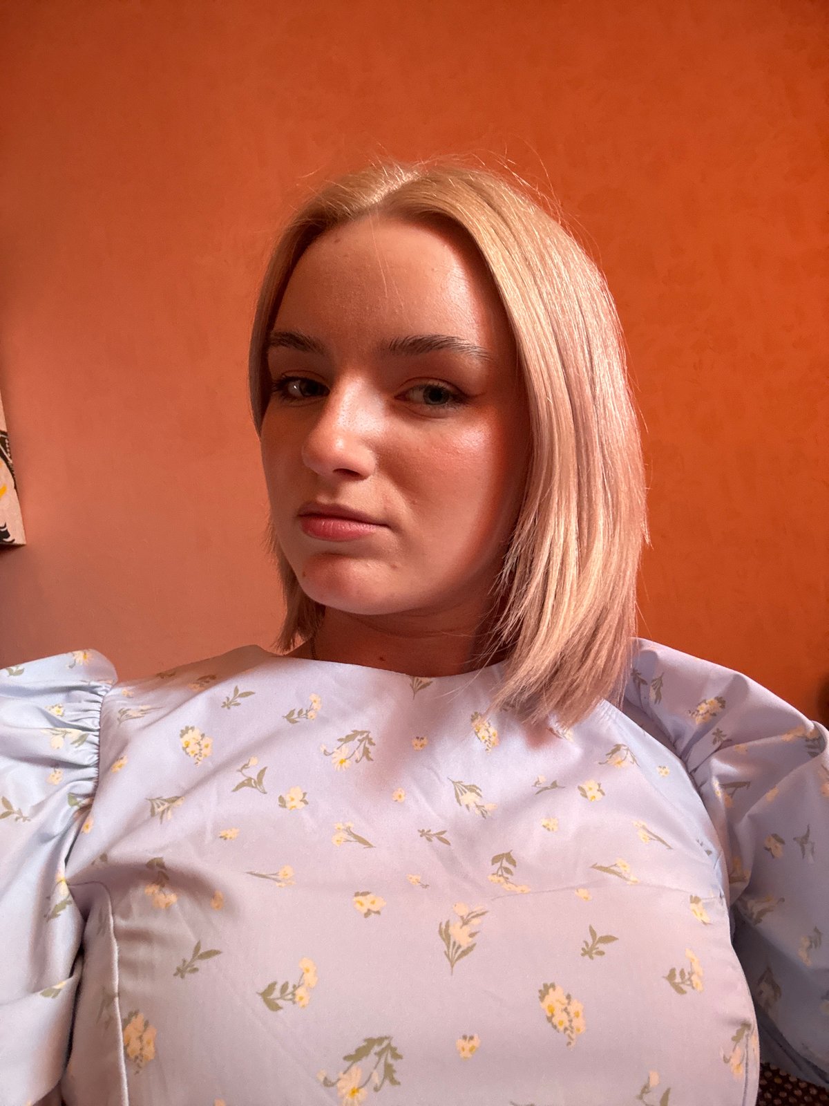 Young woman takes selfies indoors in Saint Petersburg