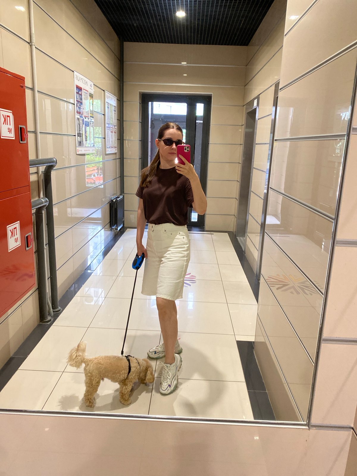Mirror selfie in a reflective tiled hallway, Sankt-Peterburg