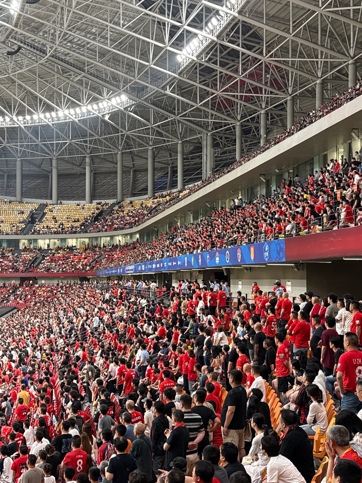 Red-shirted crowd fills indoor stadium in Longxing, China