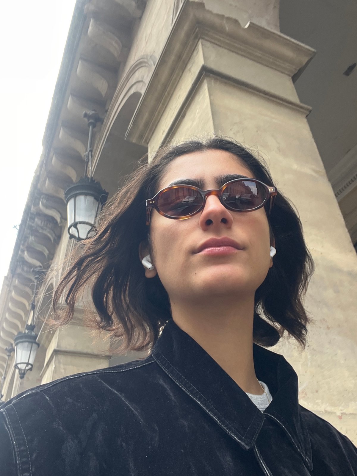 Woman takes multiple selfies on Paris street
