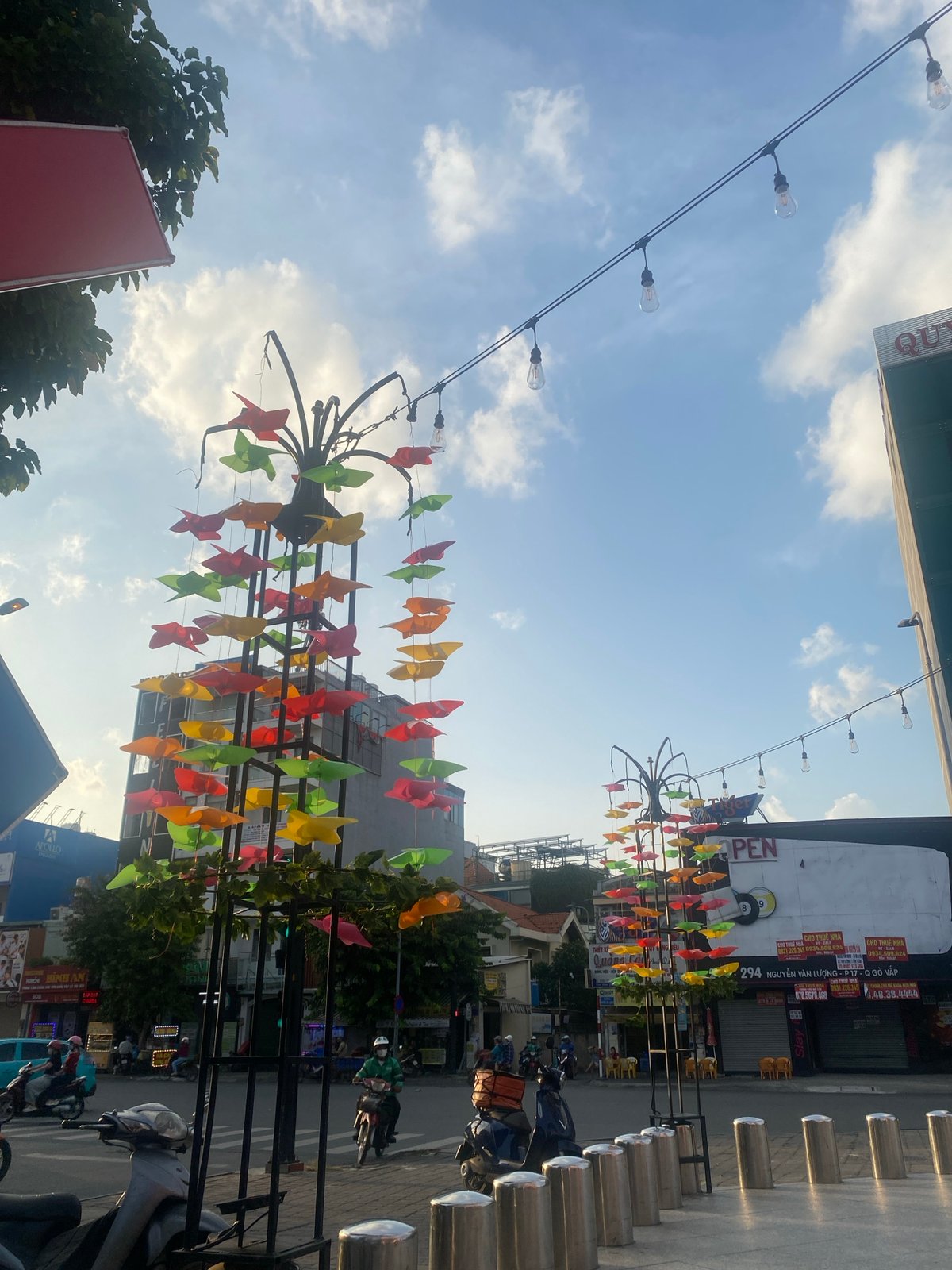 Decorated street in Thuận An with paper ornaments and light traffic