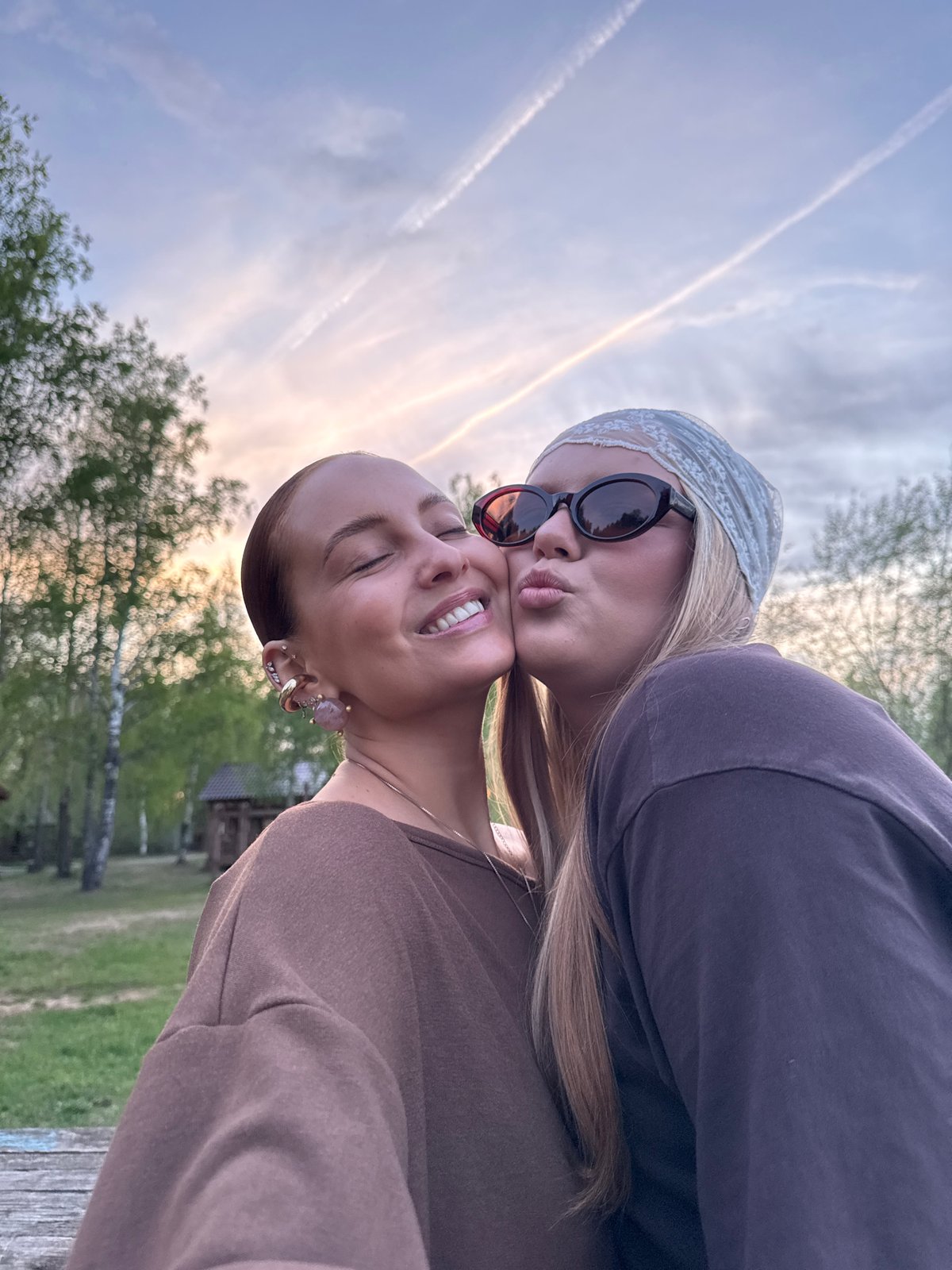Friends photograph together, duck spotted near water in Chaikovsky