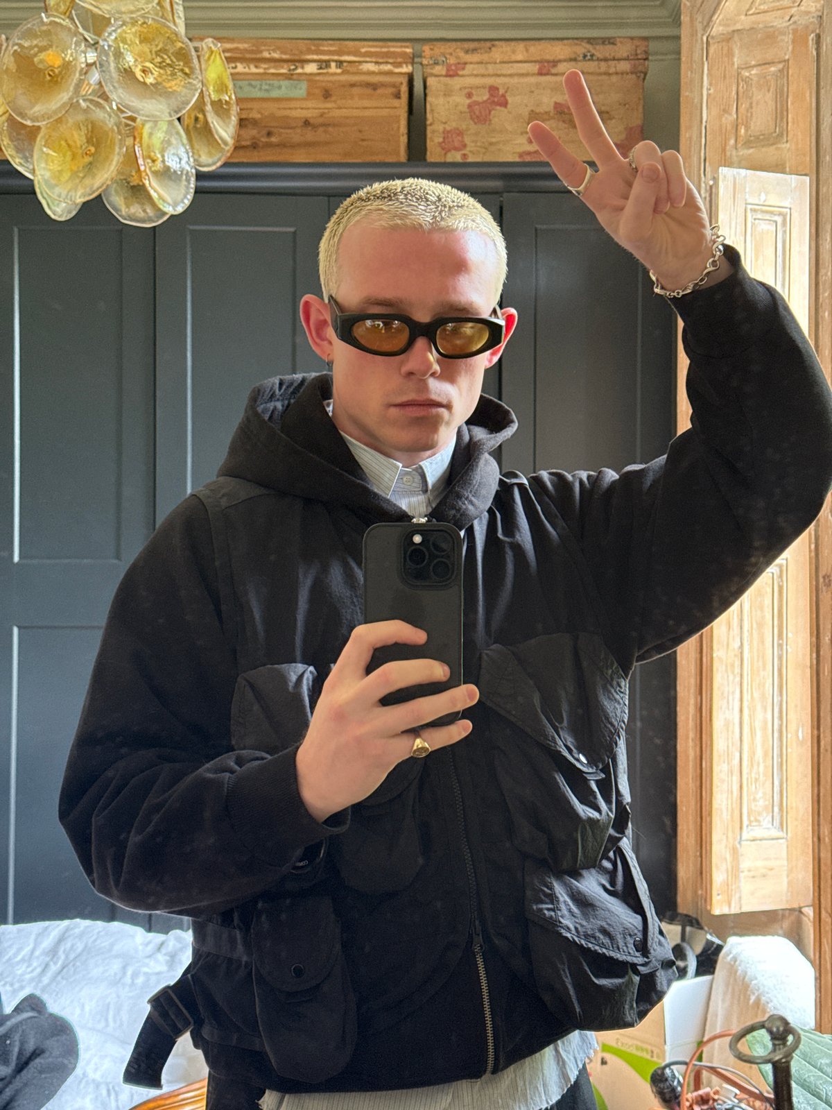Blonde-haired person takes mirror selfie in London