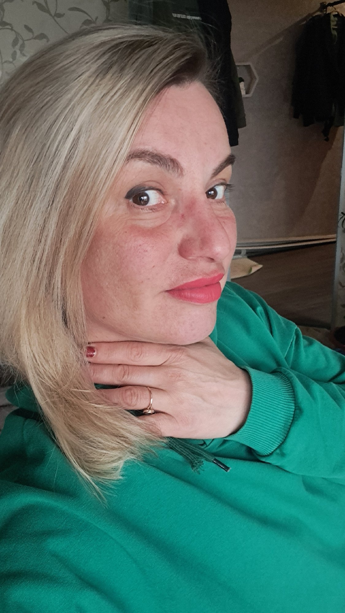 Woman in green hoodie photographed indoors in Elektrostal