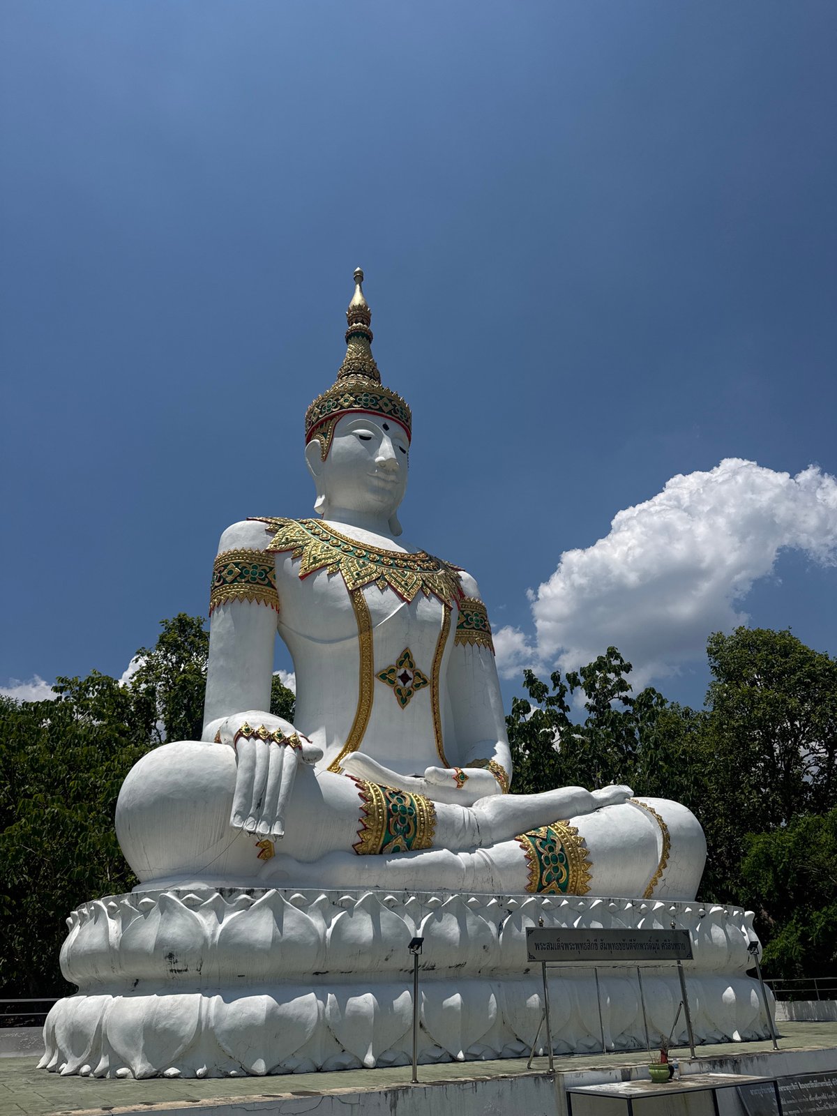 Visitors document ornate Buddha statues at Thailand temple complex