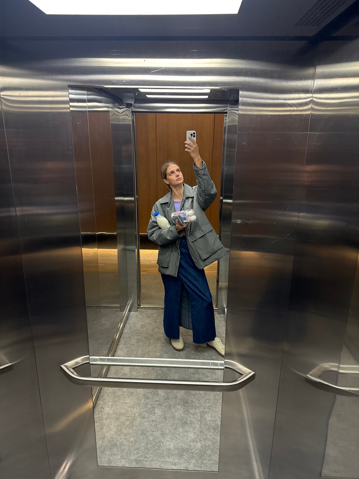 Woman Takes Multiple Selfies During Morning Elevator Ride