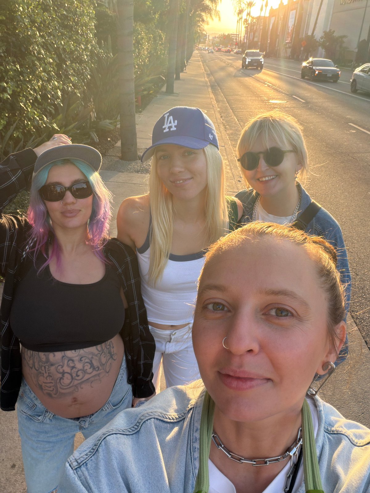 Four women photographed together on Los Angeles street