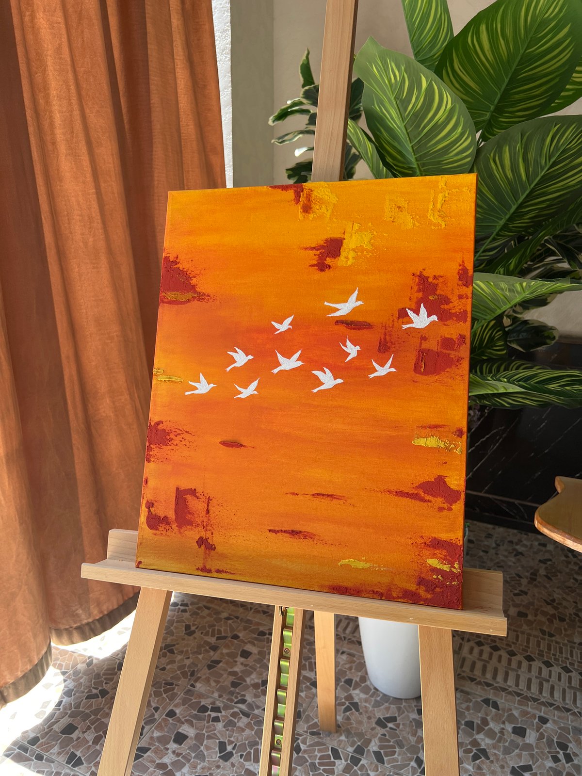 Abstract bird painting and art supplies in a Namangan studio