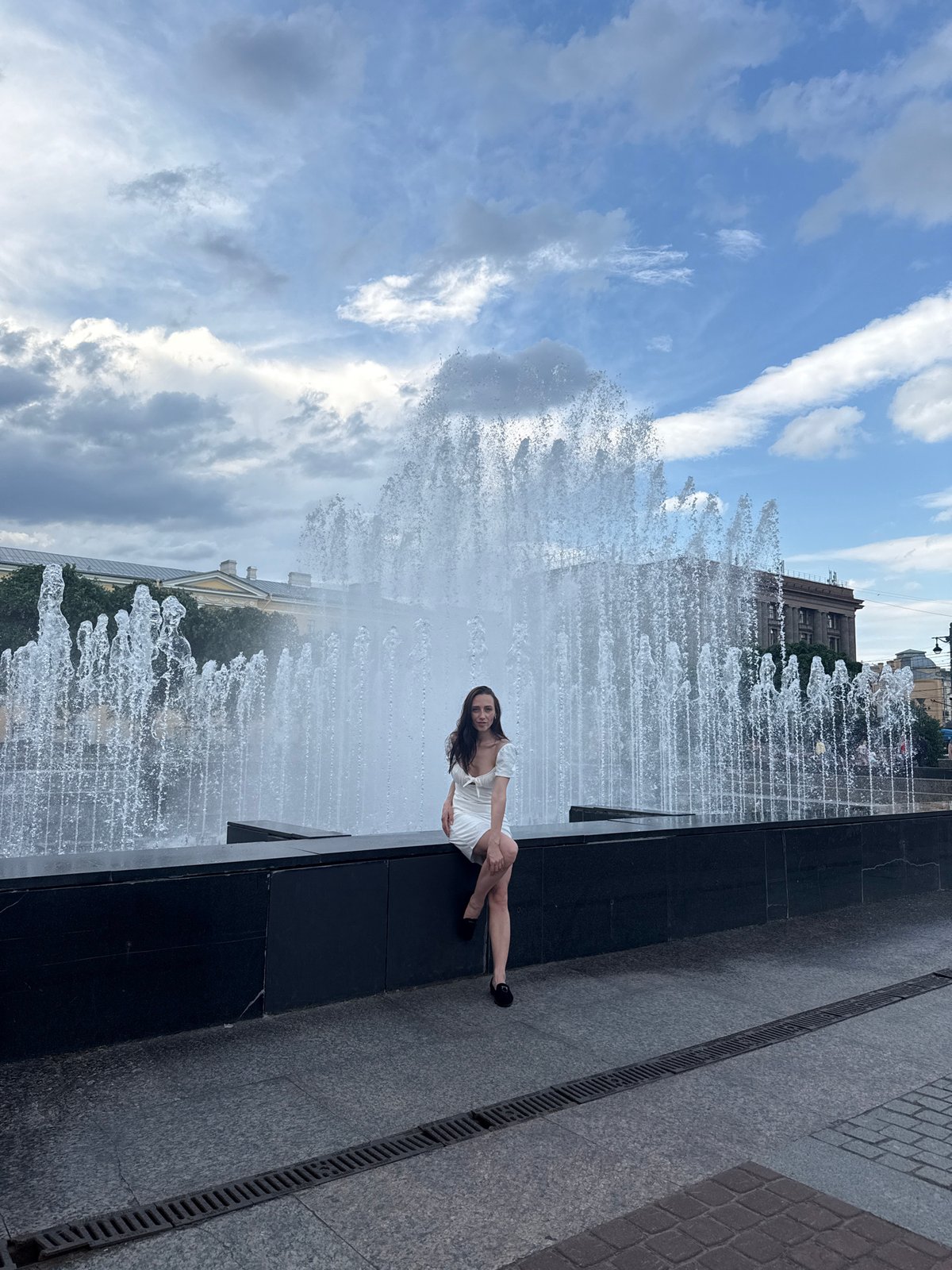 Woman poses for photos at Lenin statue fountain in Saint Petersburg