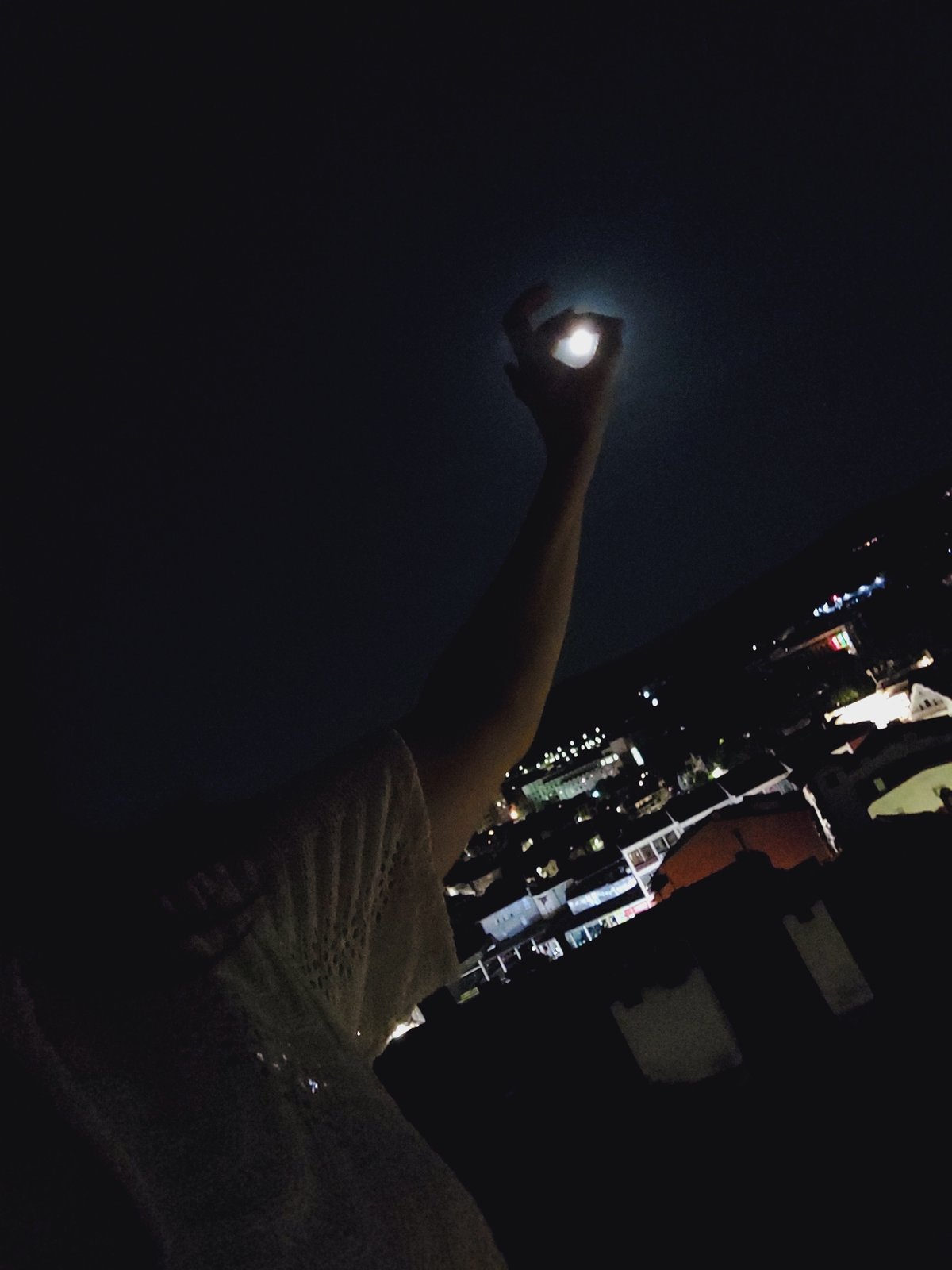 Full moon night over Veliko Tarnovo, hand reaching for the sky