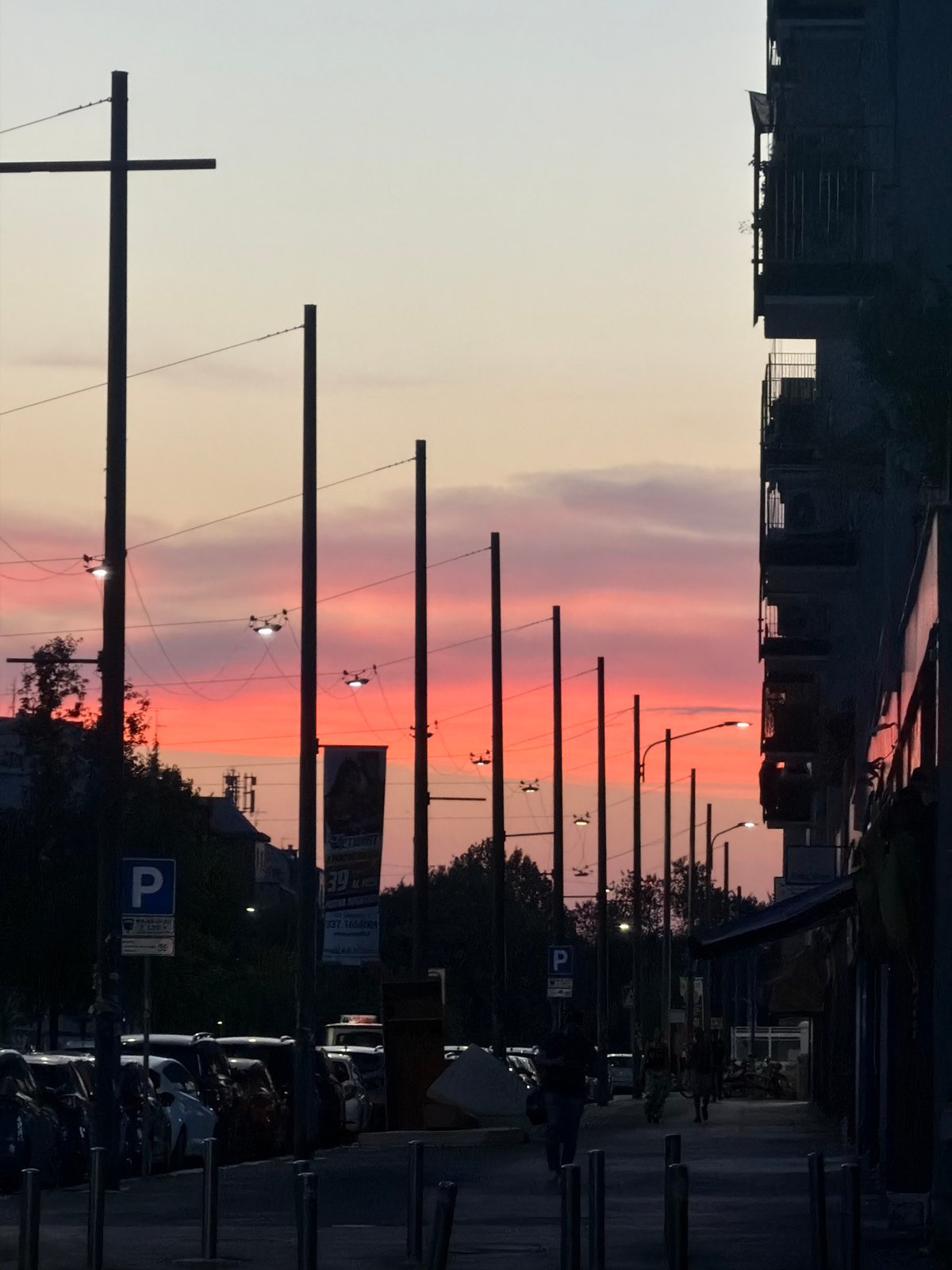 Milan sunset scene with crescent moon and vertical light column