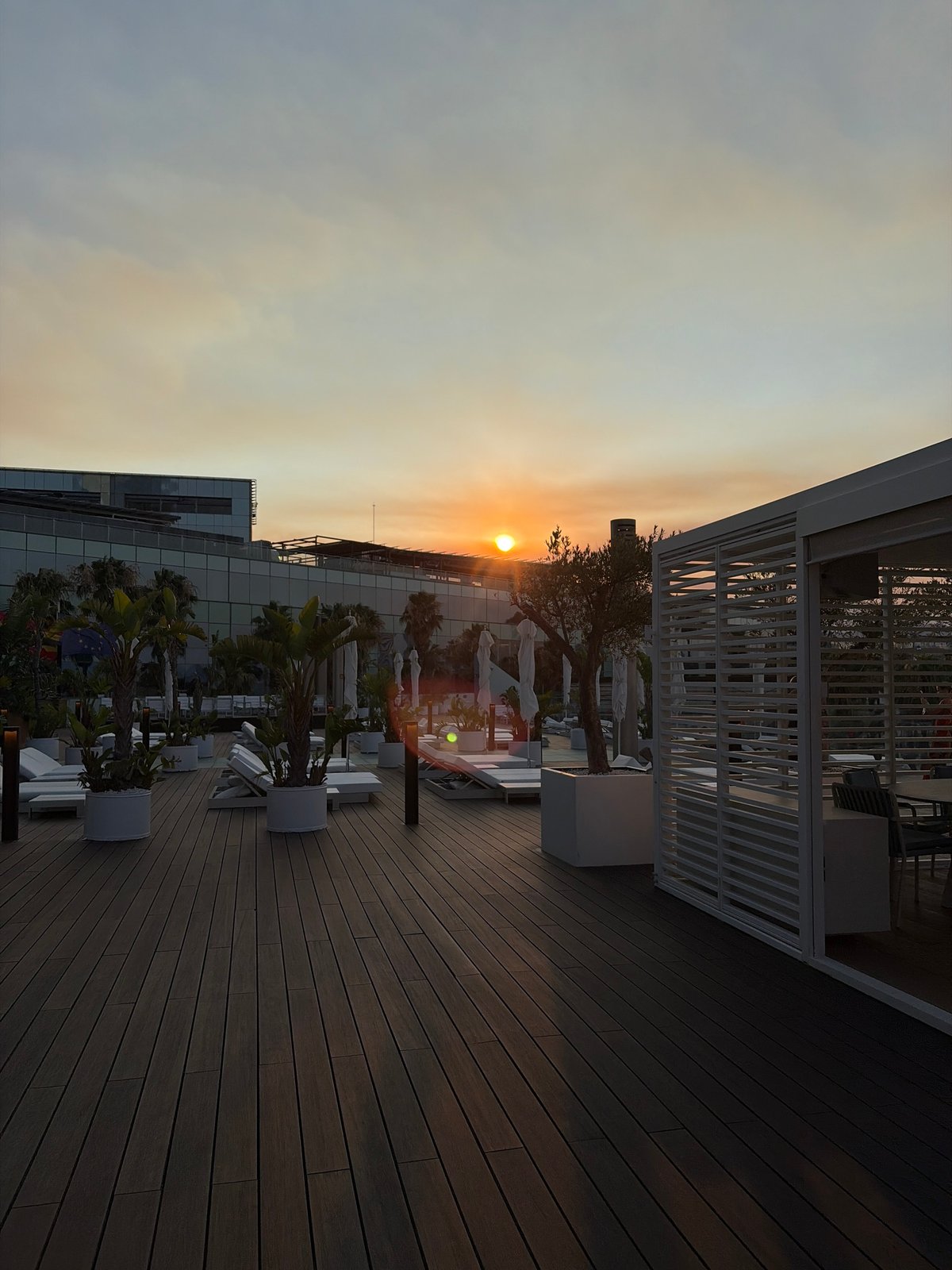 Sunset drinks at a Barcelona beach club rooftop