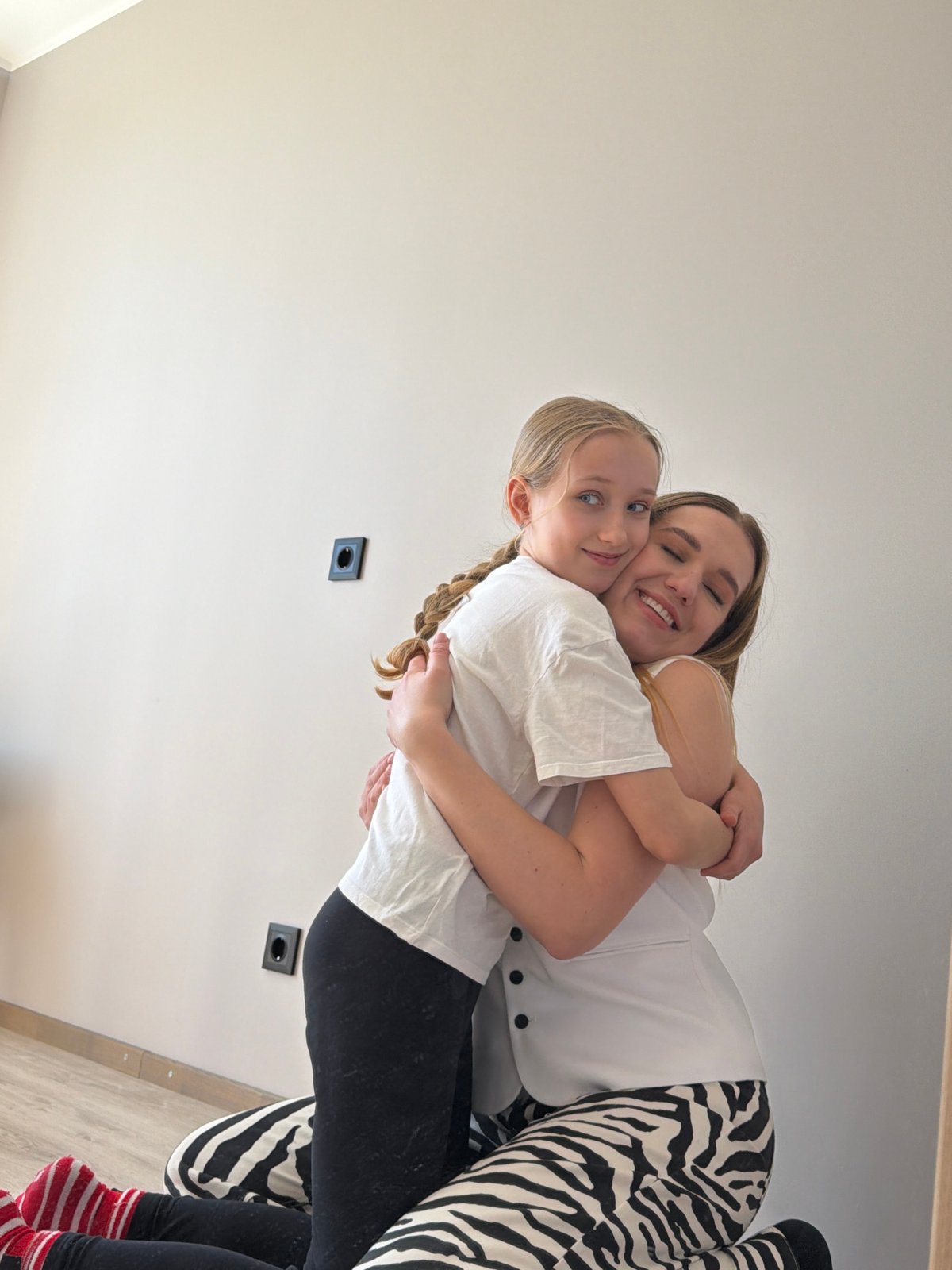 Woman and child share indoor moments in Dreiliņi, Latvia