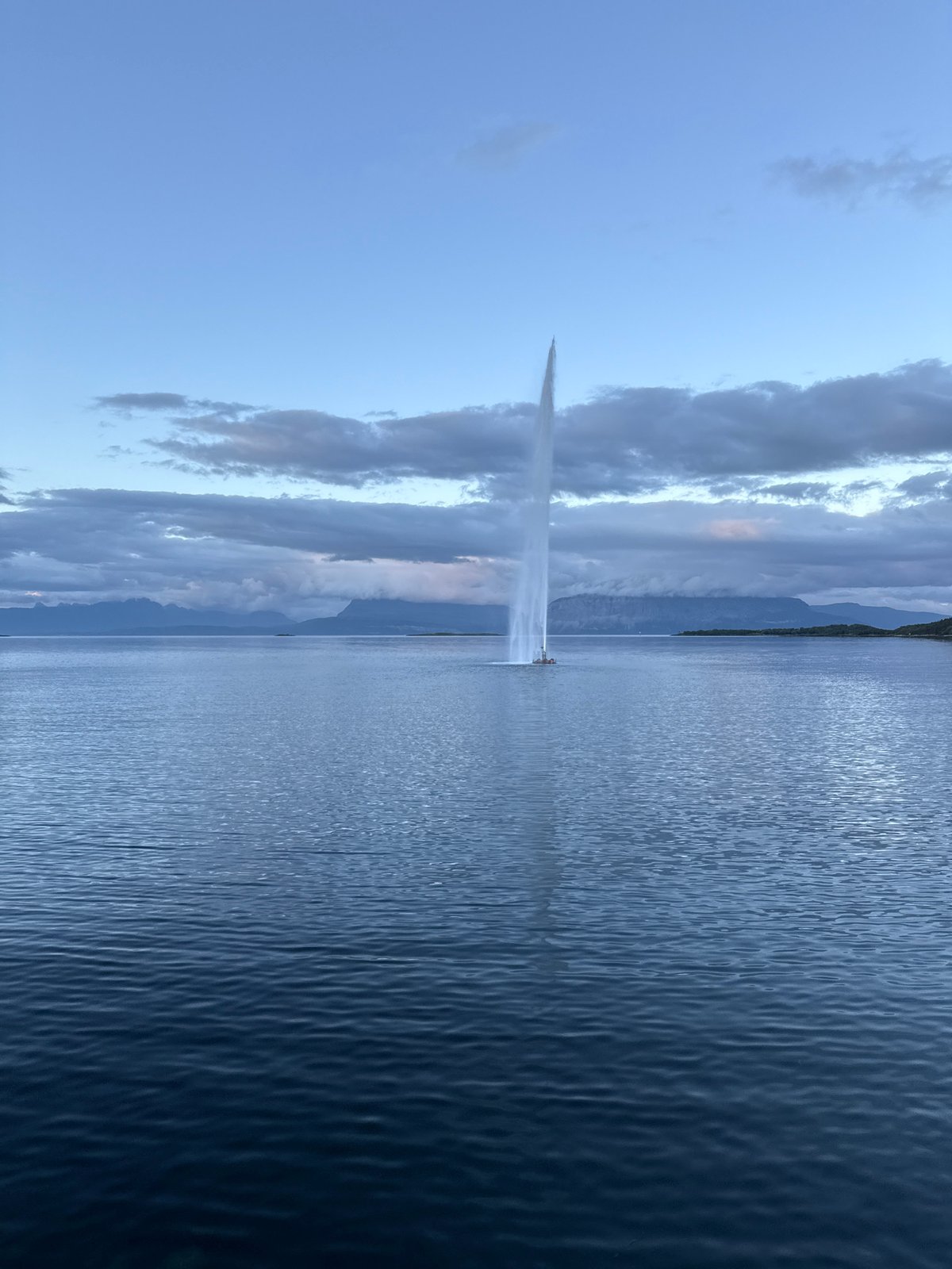 Harstad waterfront at twilight: fjord fountain and modern residential district