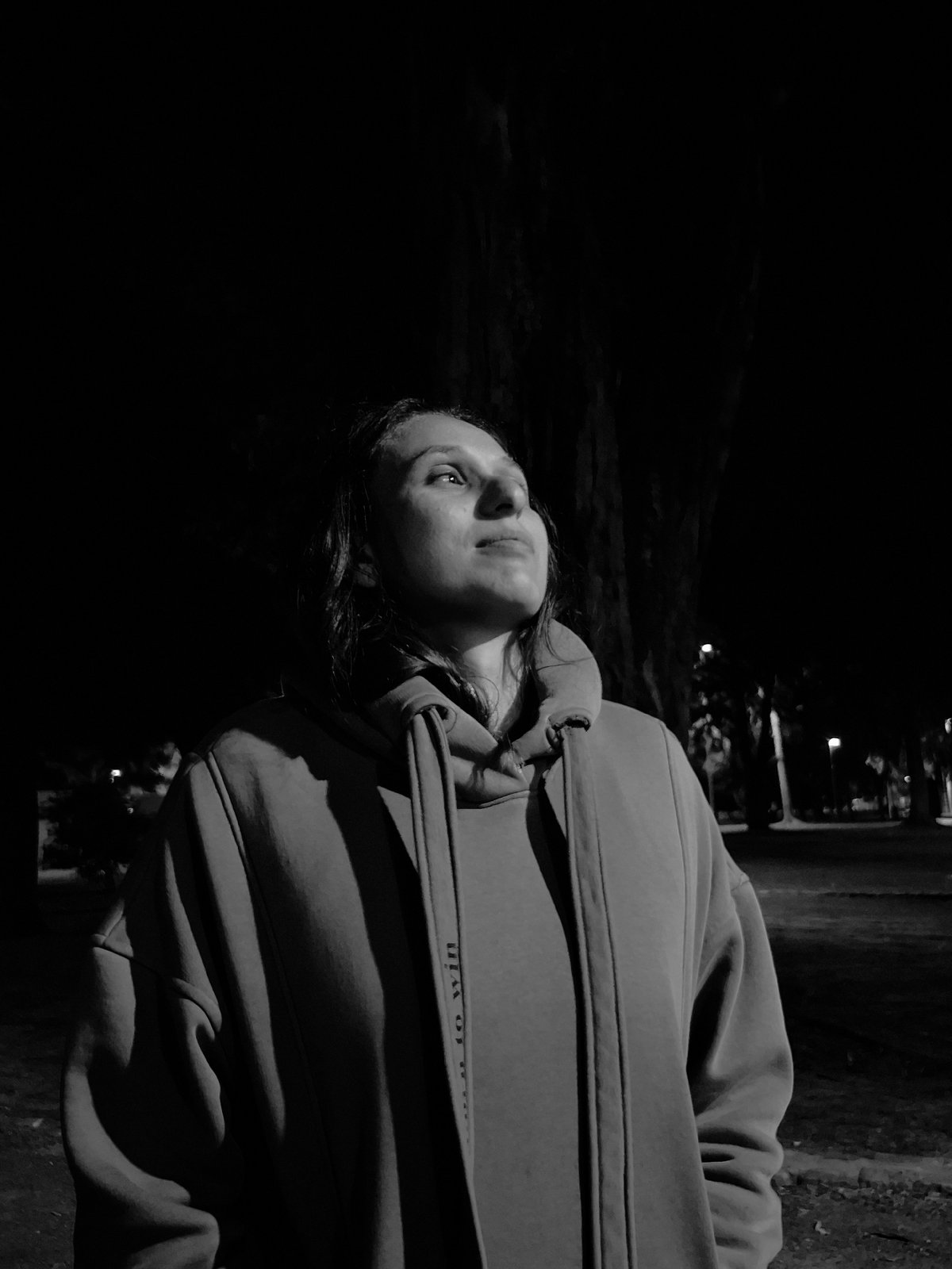 Woman trains dog in Villa Domínico park during nighttime session