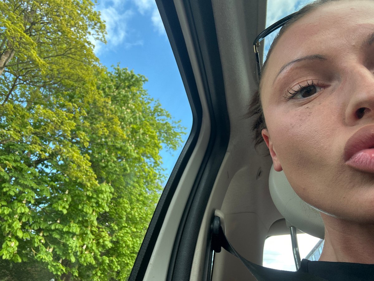 Person captures partial selfie from inside car in Wealden