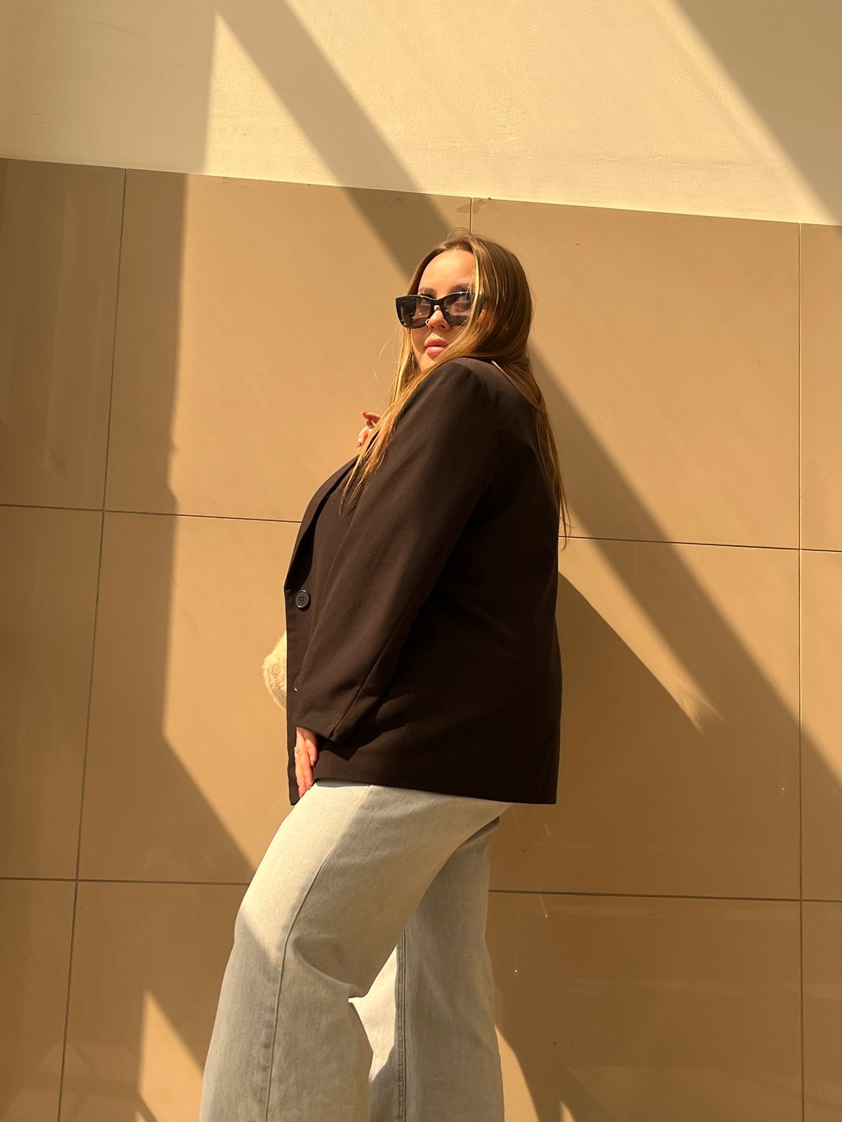 Woman in sunglasses photographed at multiple Novopokrovskaya locations
