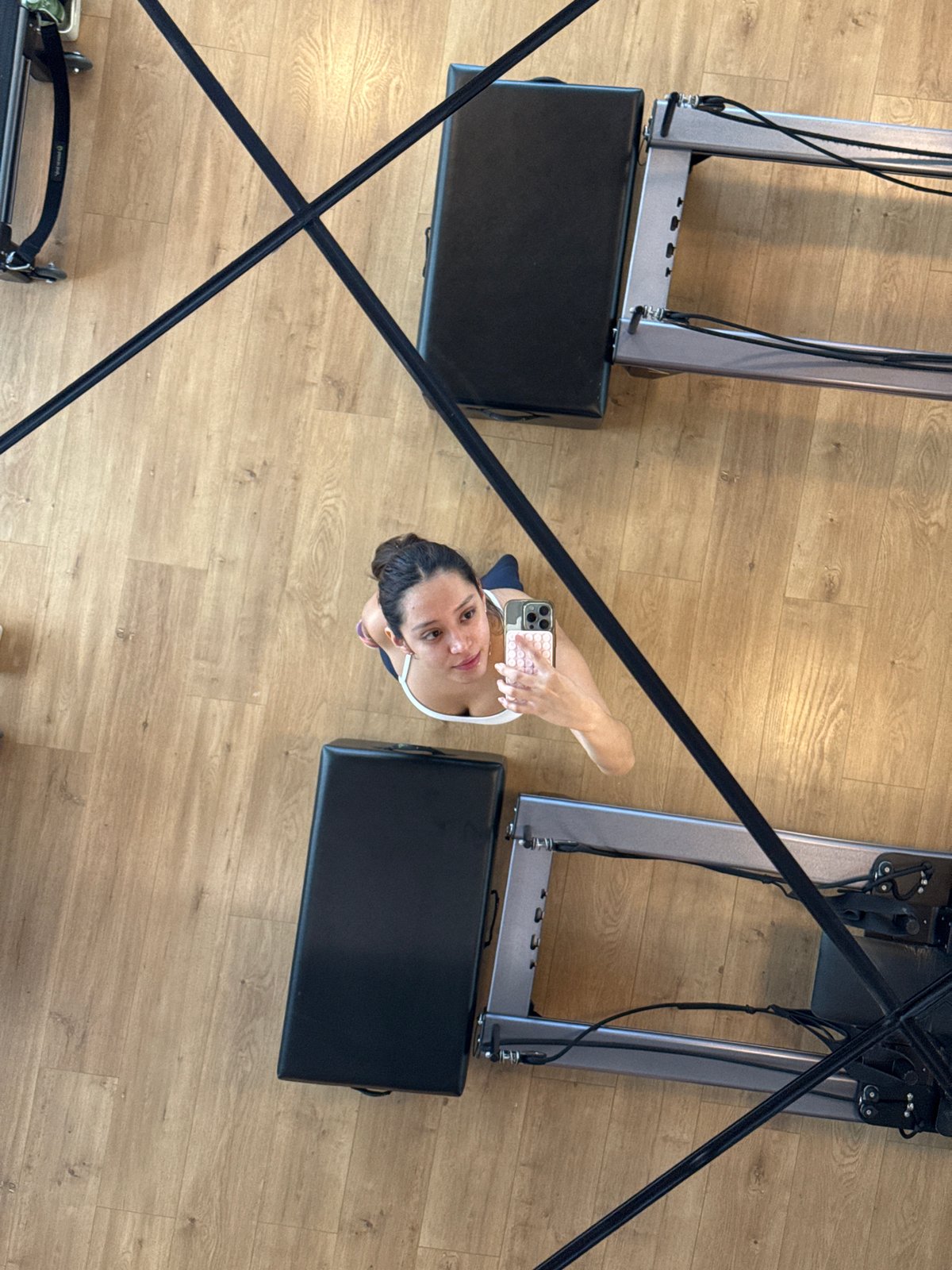Inside a Puebla Pilates studio, reformers and mirrors.