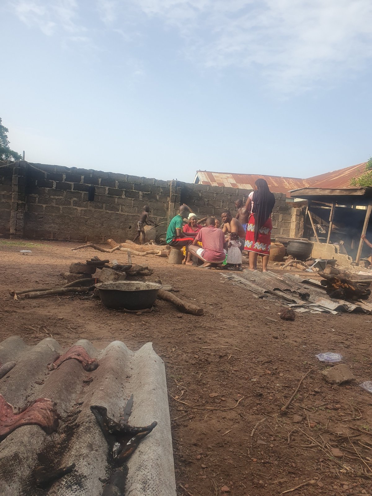 Community gathering observed near brick structure in Idah, Nigeria