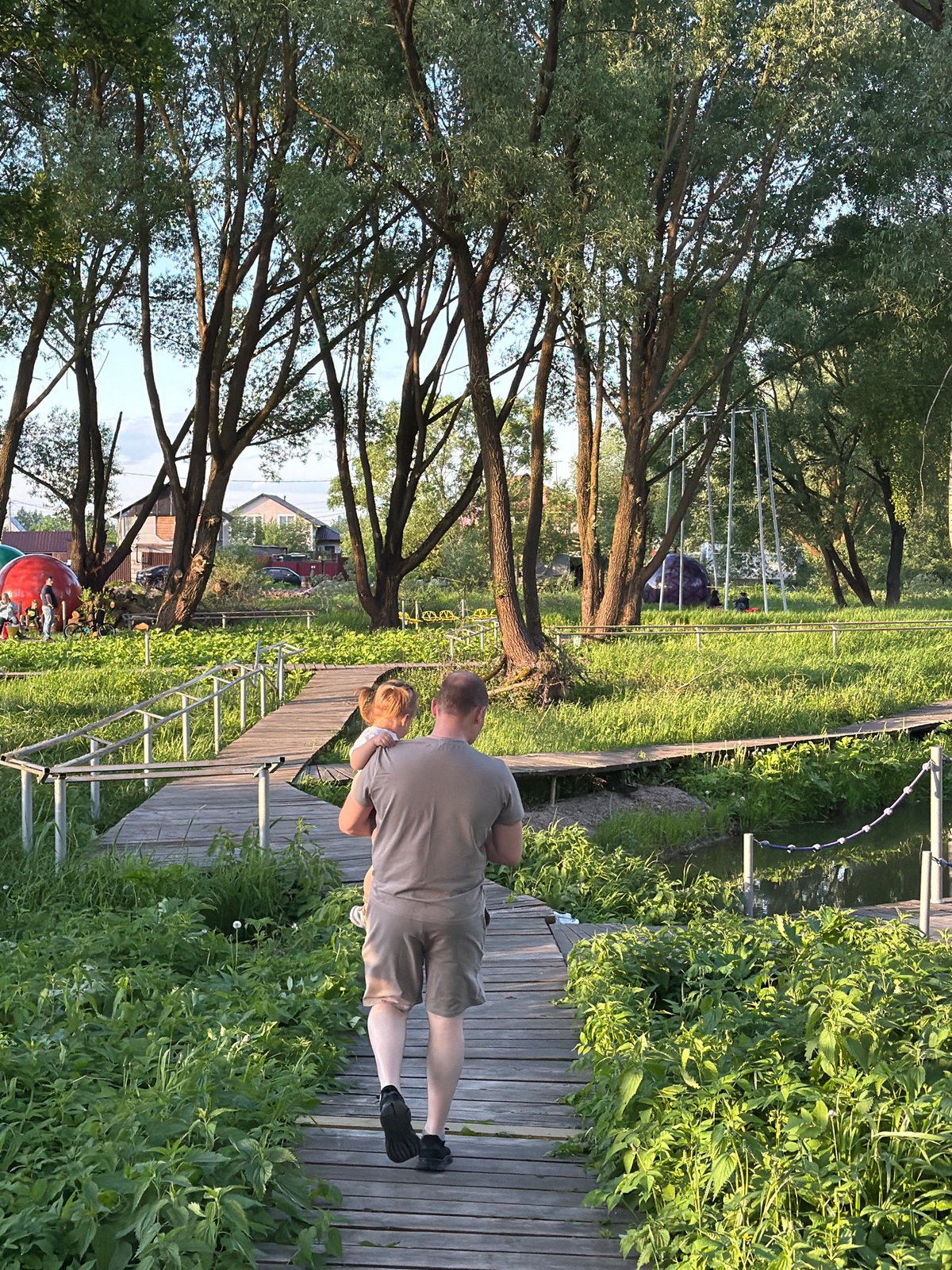 Family enjoys afternoon playground visit in Sin'kovo, Russia