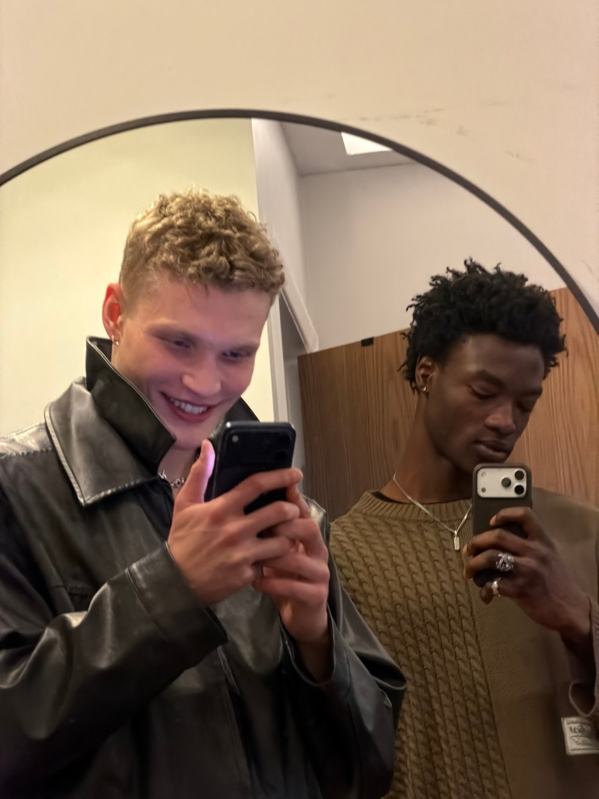 Two young men take mirror selfies in London