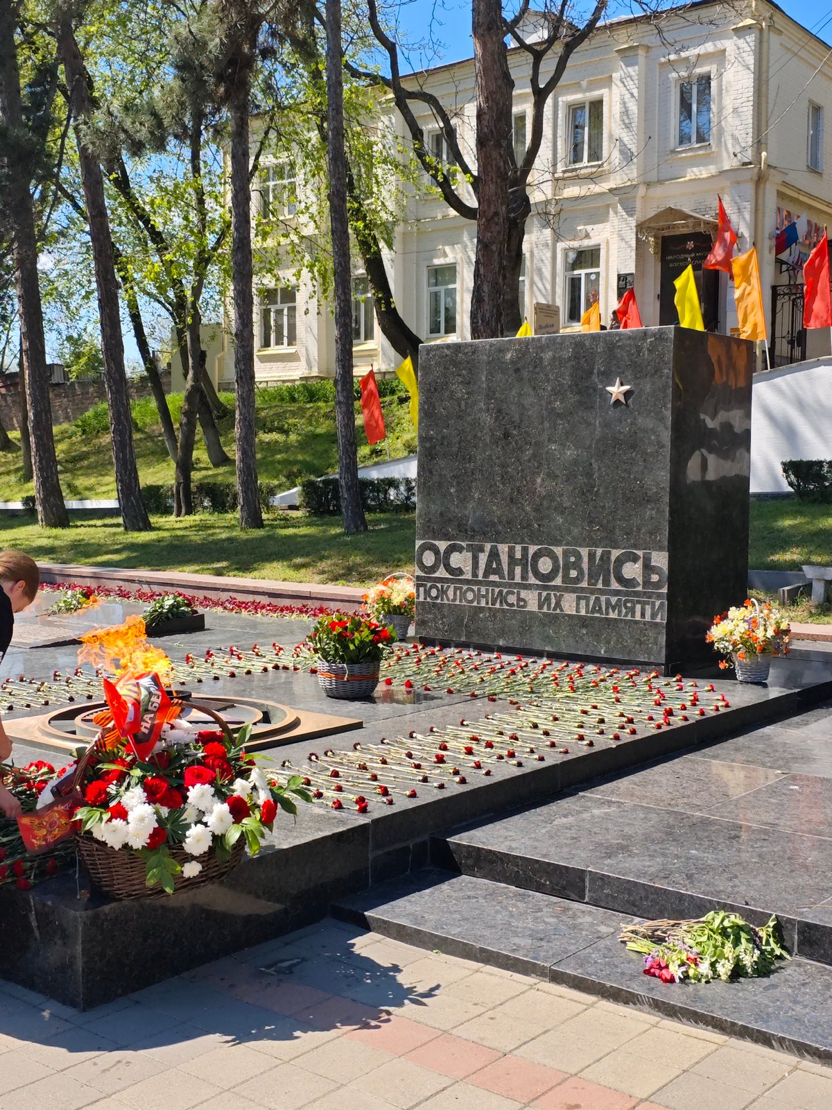 Woman places flowers at war memorial in Pyatigorsk
