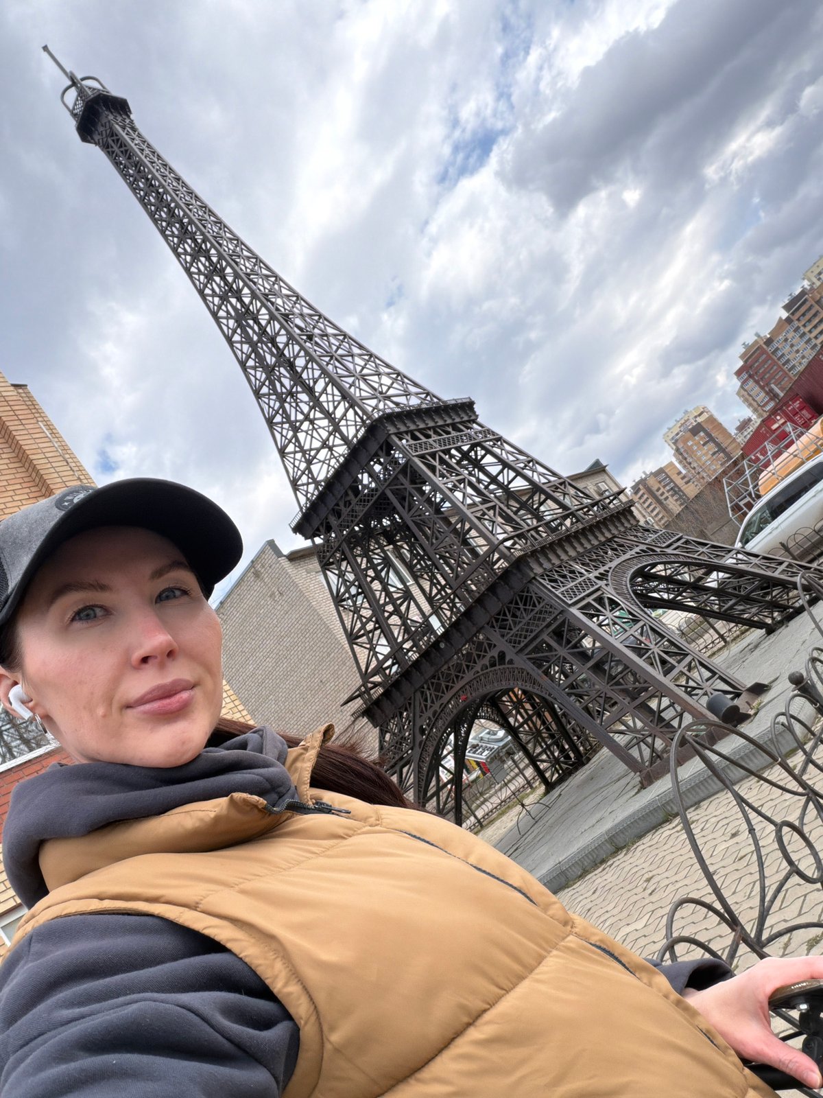 Woman poses for selfie at Eiffel Tower replica in Perm