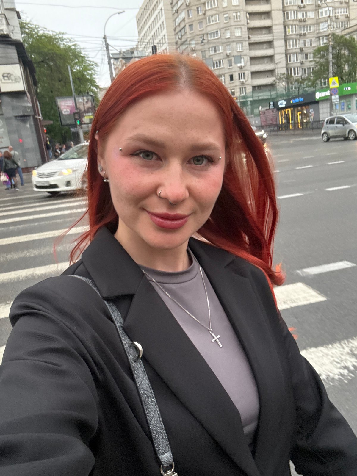 Woman takes selfie on Rostov-on-Don crosswalk, boy nearby