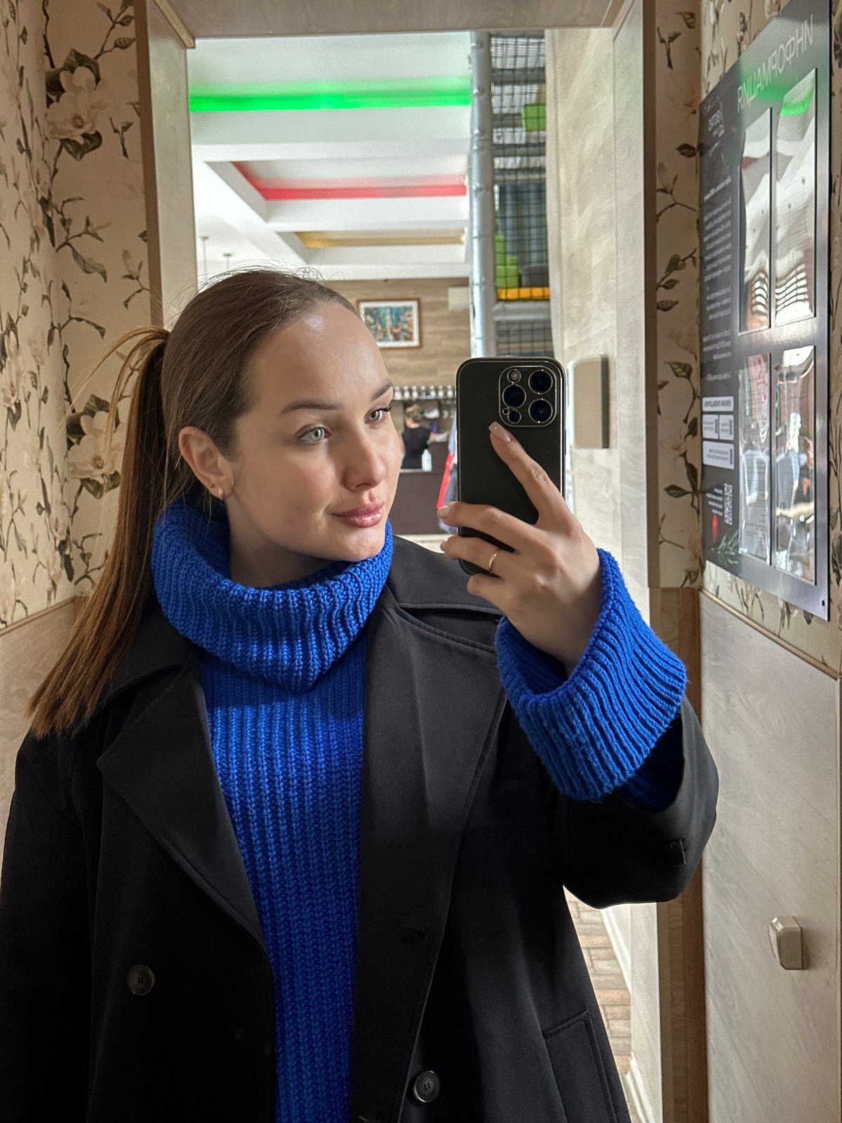 Woman documents indoor visit with selfies and cat in Chaikovsky