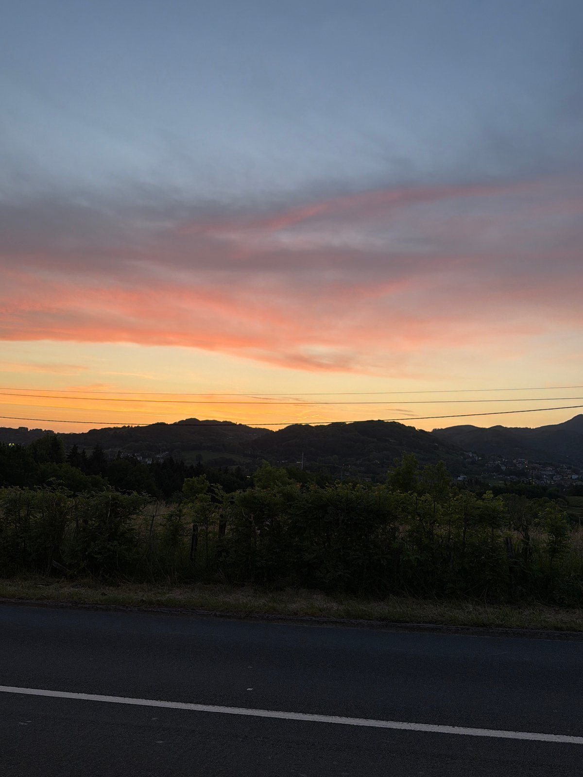 Dawn cyclist crosses pedestrian walkway in Errenteria, Spain