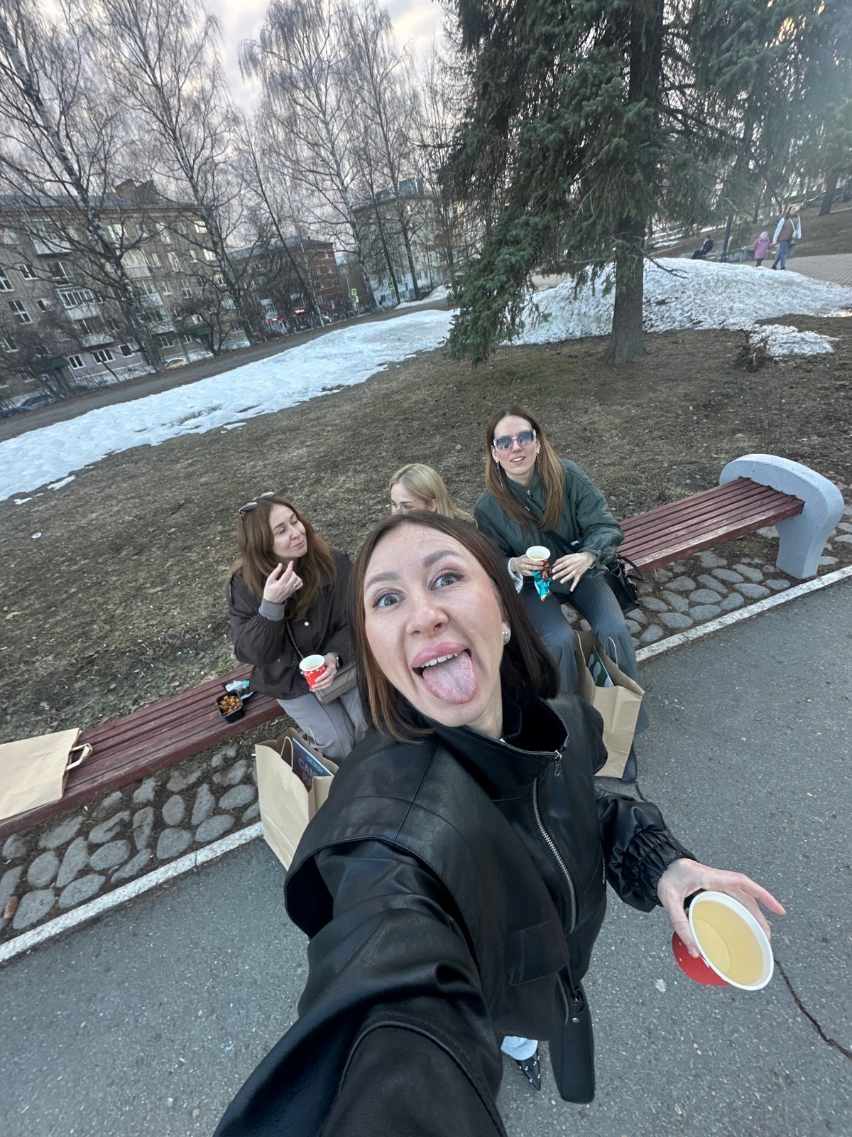 Four women share drinks, selfies on Izhevsk park bench