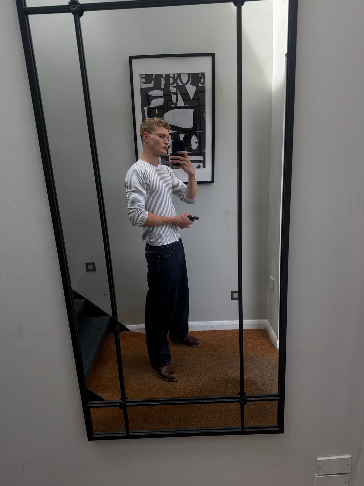 Mirror selfie in a London room, casual daytime fit