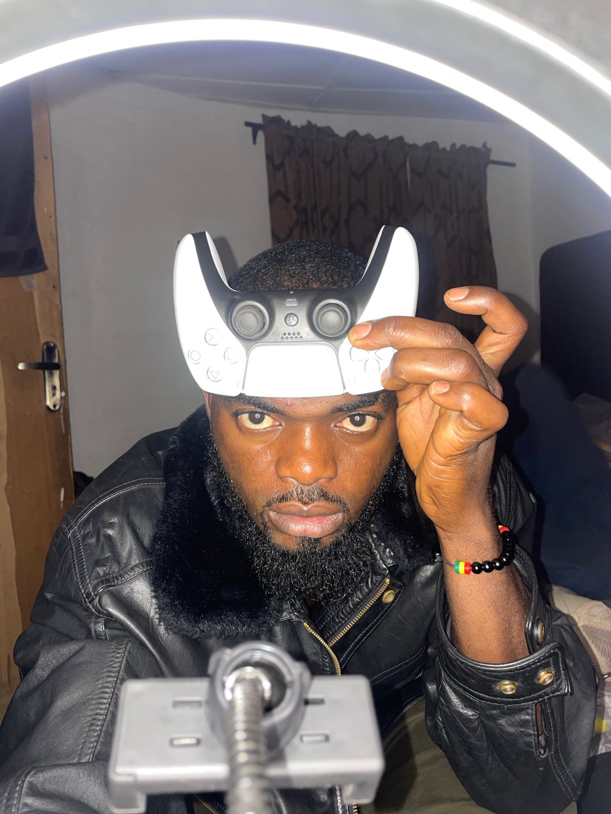 Man poses with PlayStation controller in Jos gaming session