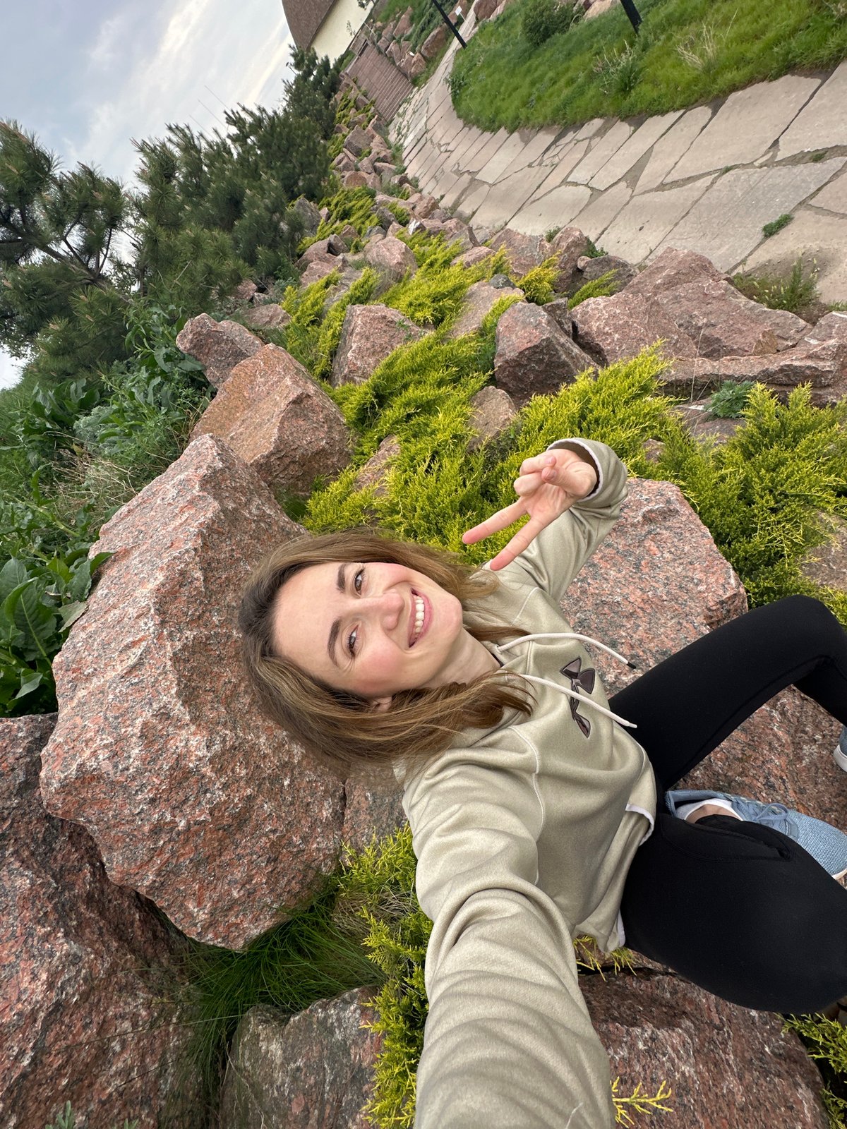Two women pose for photos at Zakharivka rock formations