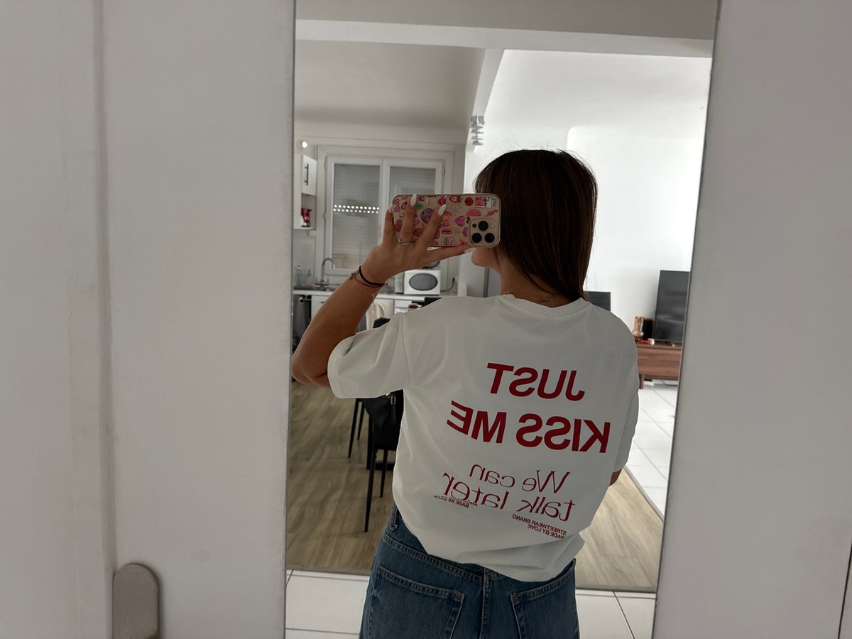Woman takes selfies in tour merchandise shirt in Cannes