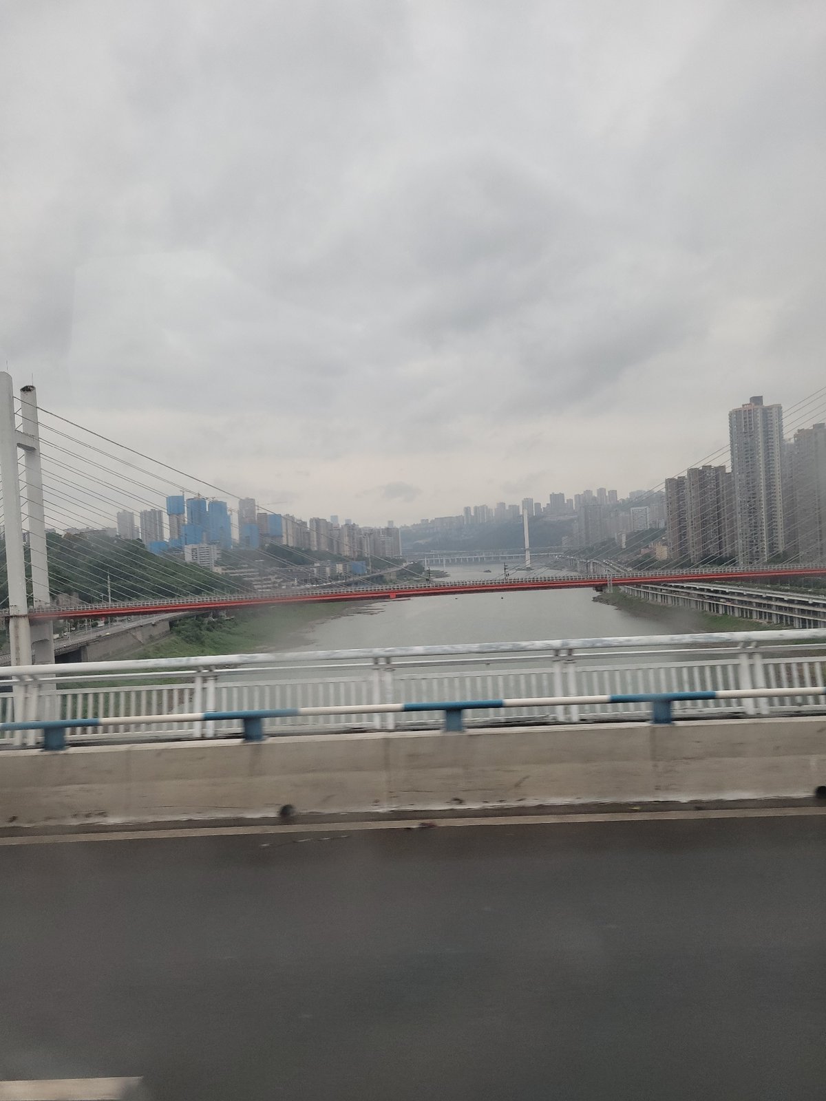 Bridge views capture foggy Chongqing cityscape, unusual parked car