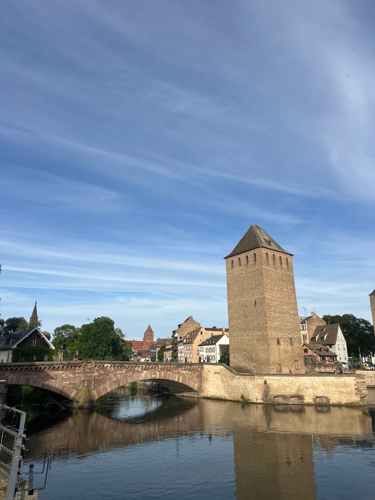Tourist documents medieval towers and canal boats in Strasbourg