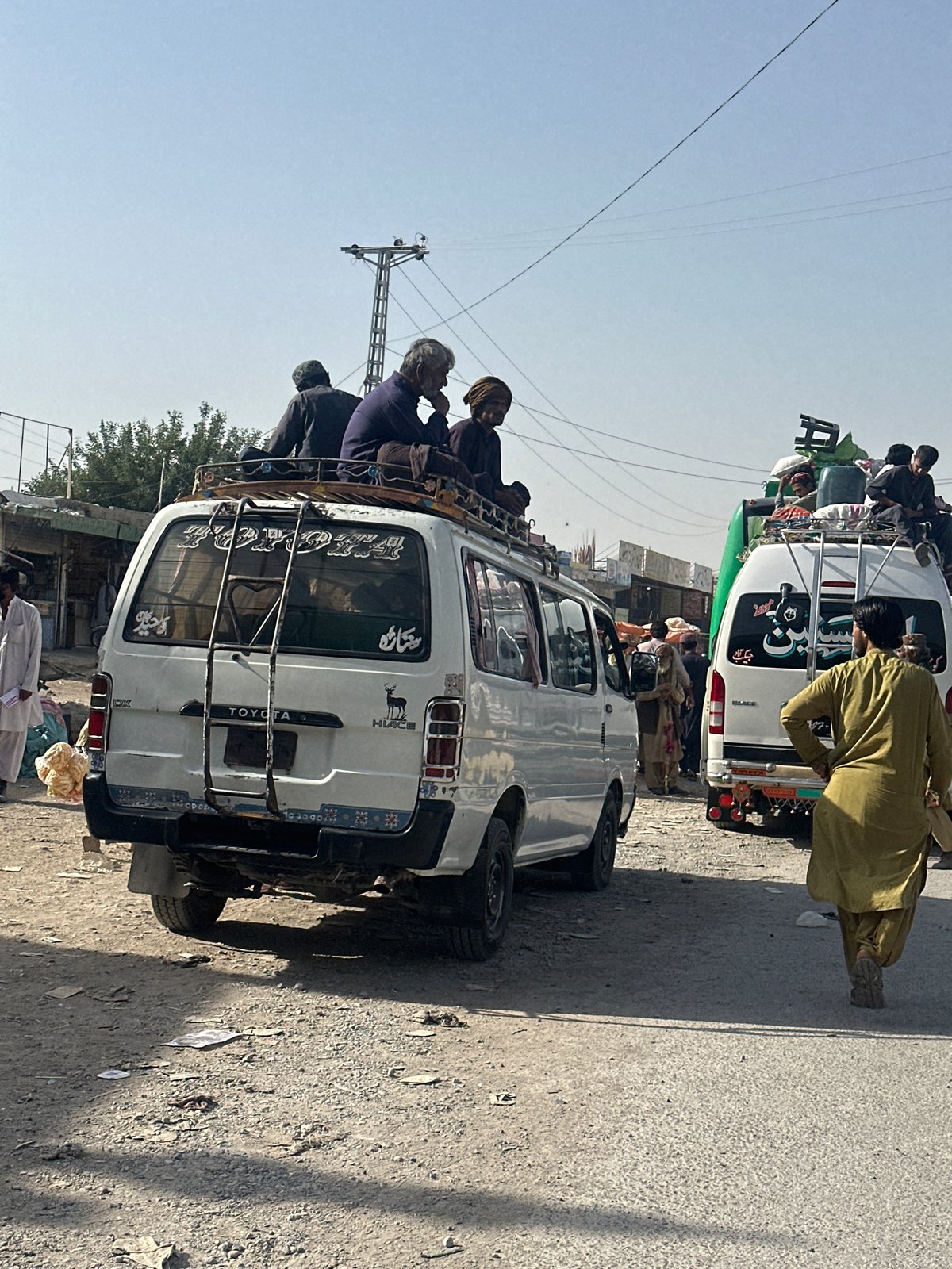 Overloaded vans spotted on Quetta street during sunny day