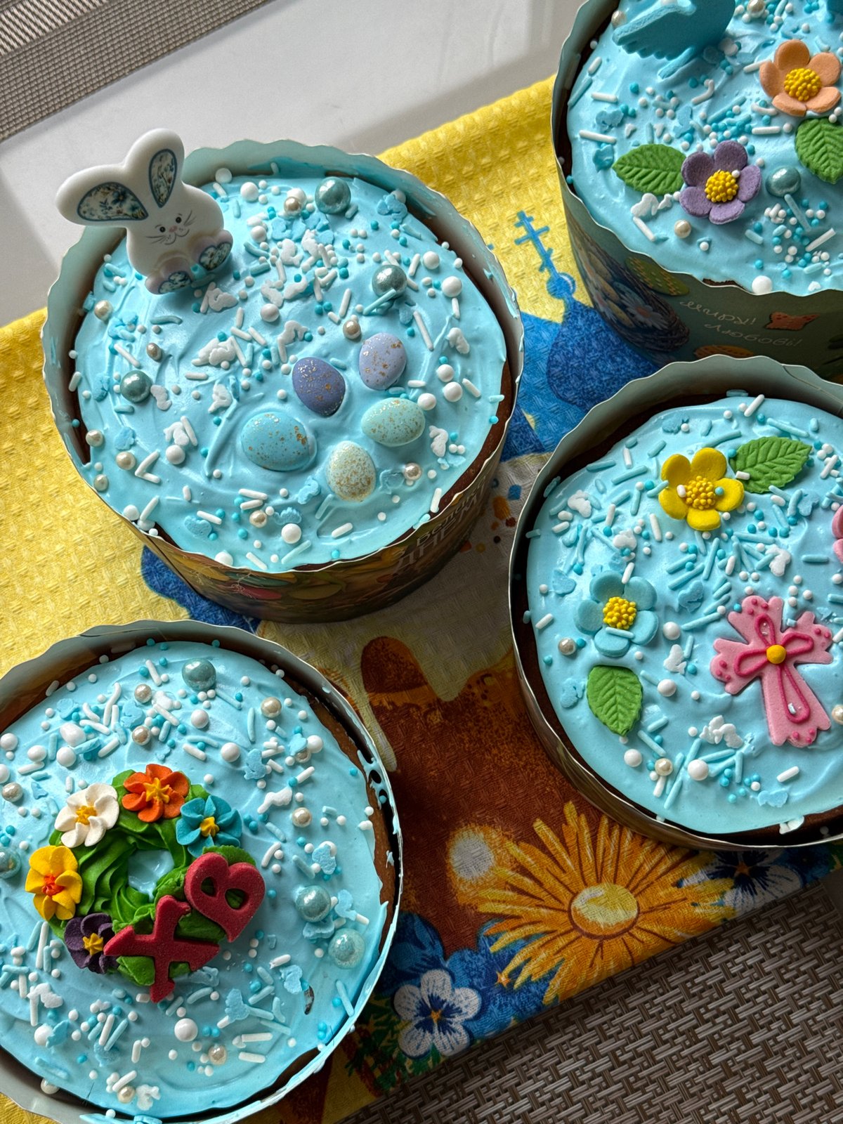 Blue-frosted Easter cakes displayed on decorated tables in Kyiv