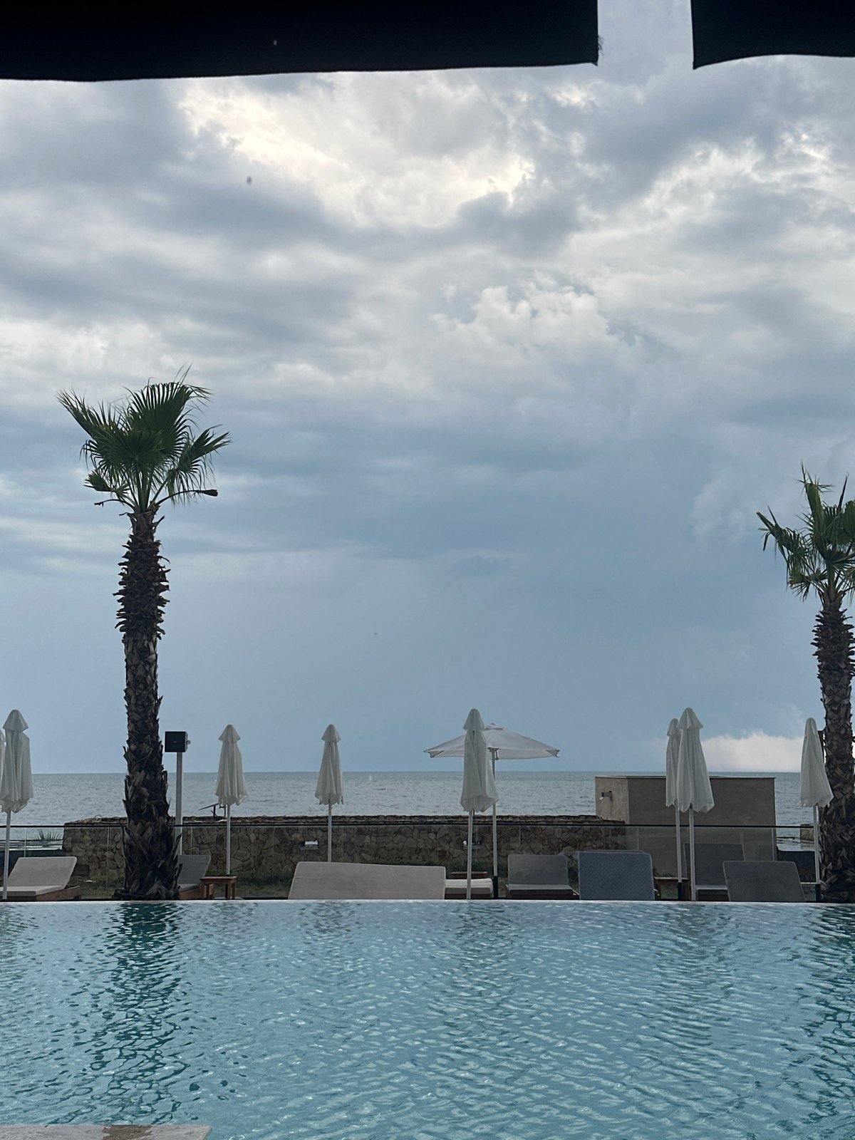 Rainy-day resort: infinity pool views and indoor dining