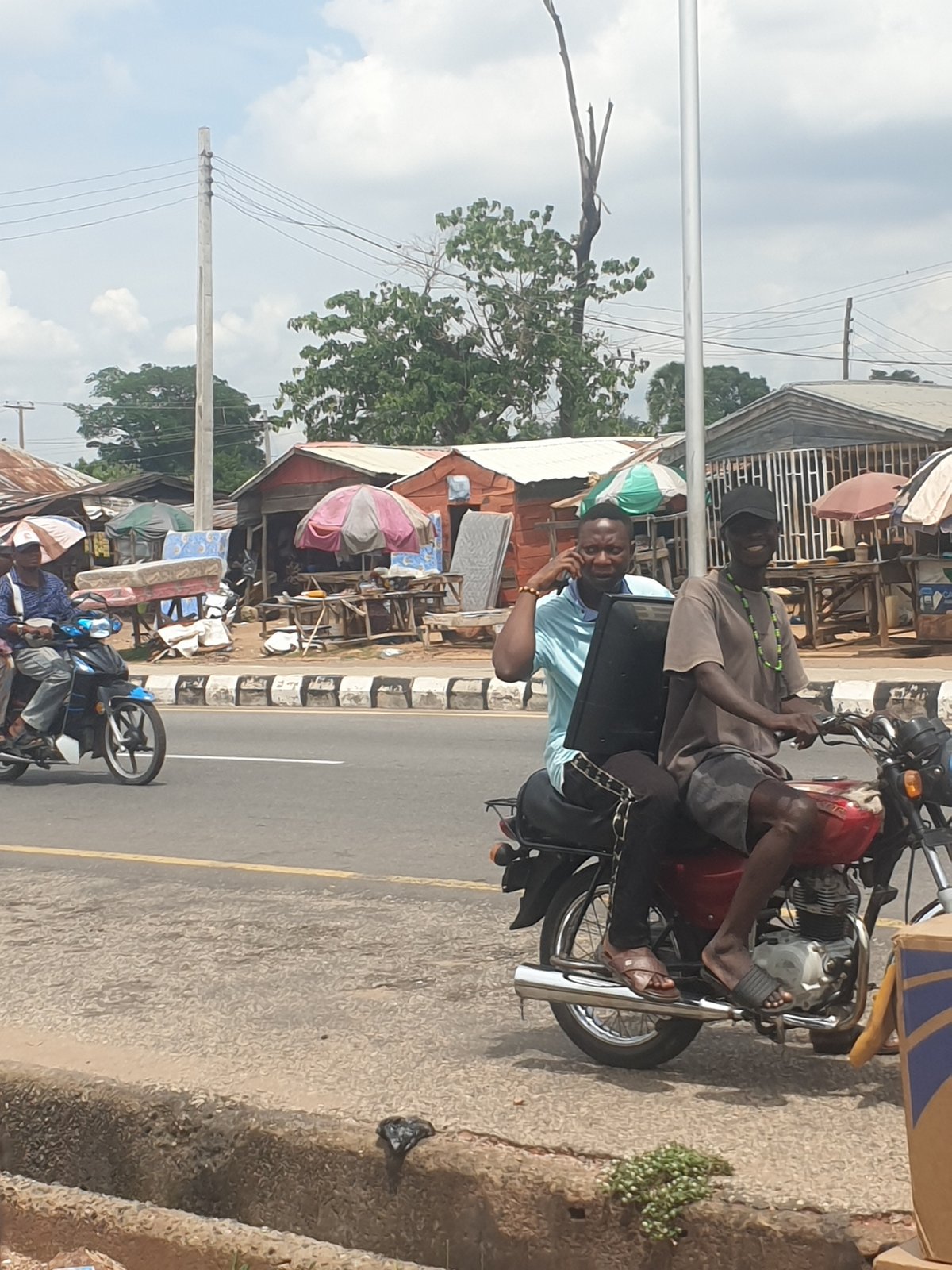 Urban street scene with motorcycles, construction equipment observed