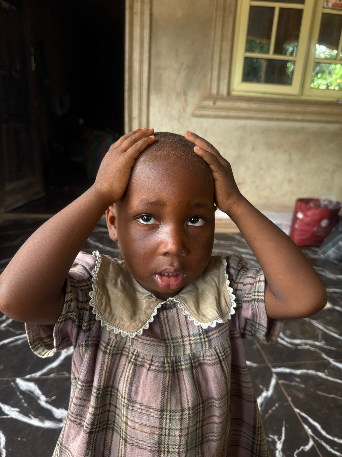 Children photographed in indoor setting in Eziudo, Nigeria